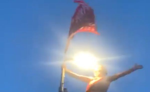 (Video) LFC fan in red mankini sings ‘We Are The Champions’ from atop a lamppost
