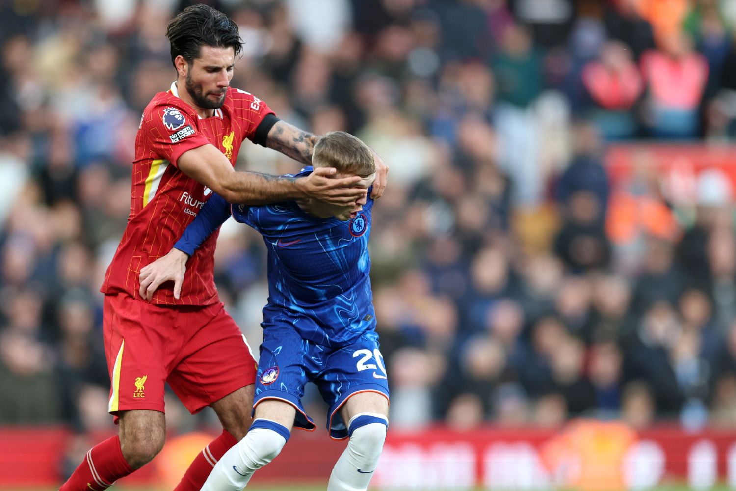 Cole Palmer struggles to keep the ball against Dominik Szoboszlai