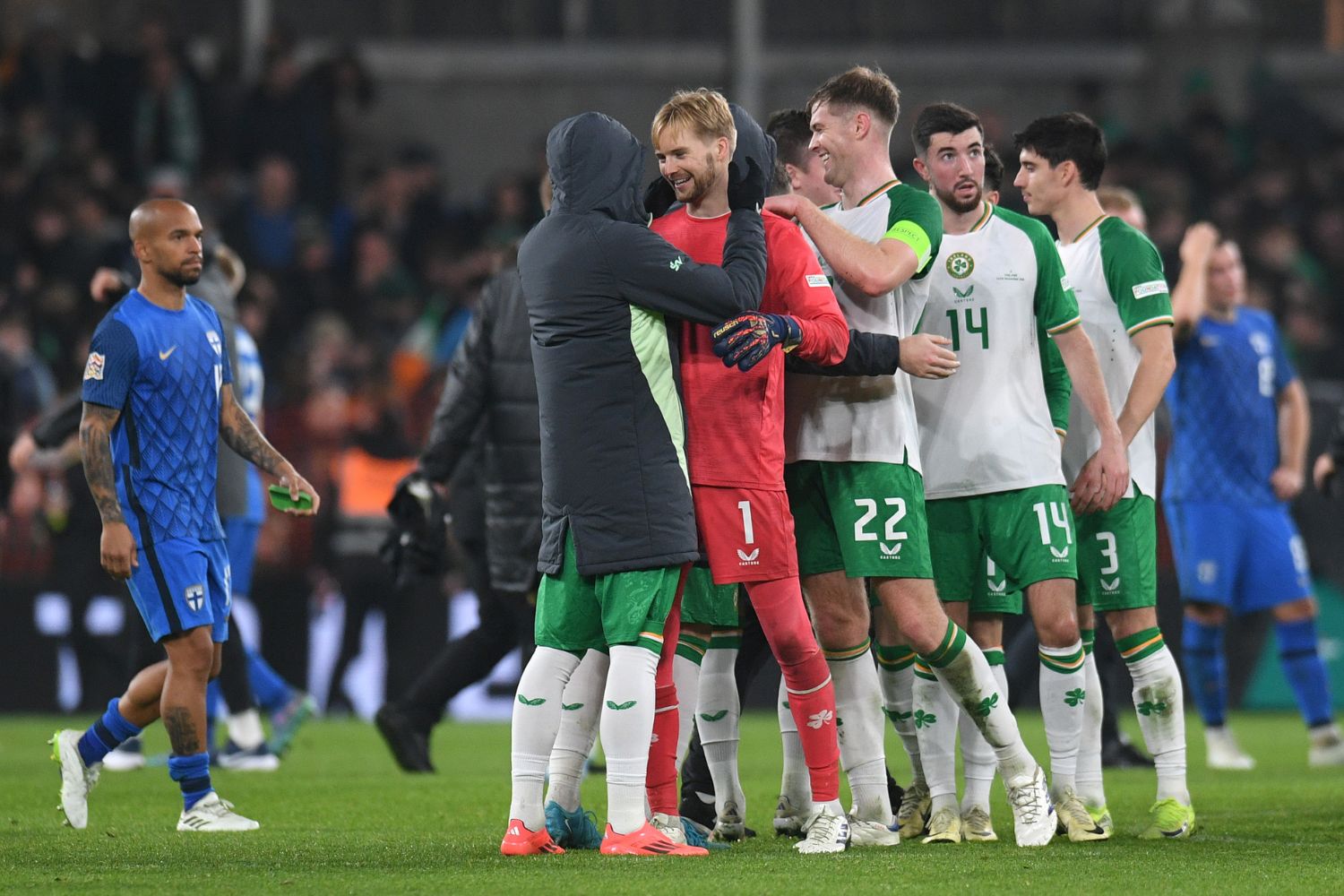 Caoimhin Kelleher congratulated by Ireland teammates after his heroics