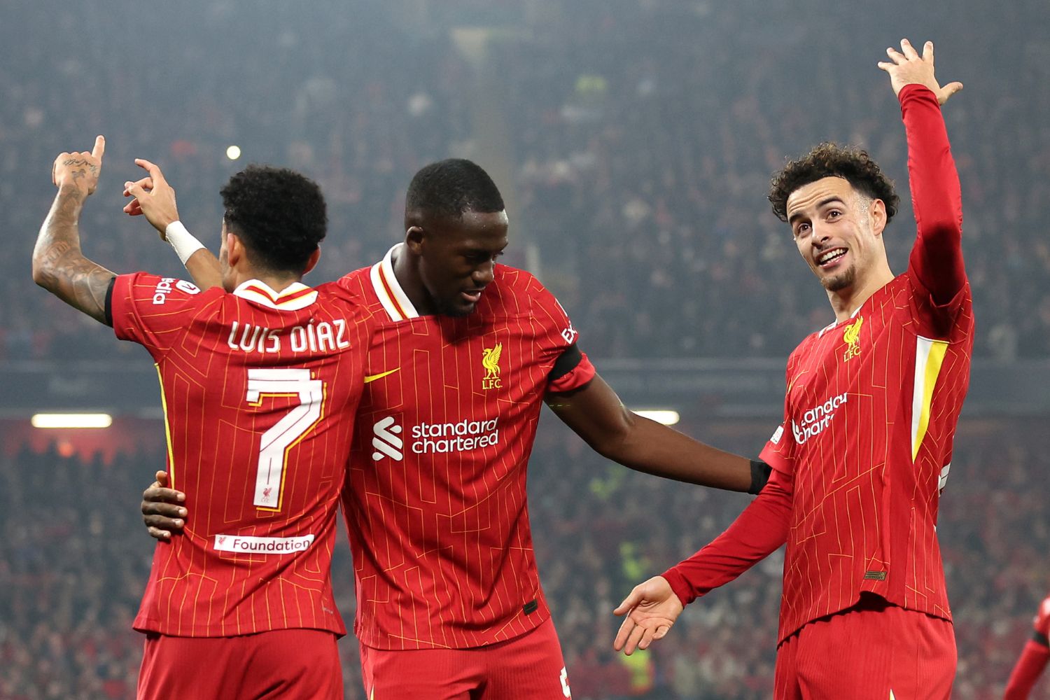 Konate celebrates with Jones and Diaz at Anfield