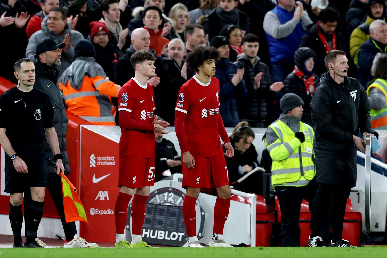 James McConnell and Jayden Danns of Liverpool prepare to enter the pitch as substitutes during the Premier League match between Liverpool FC and Luton Town at Anfield