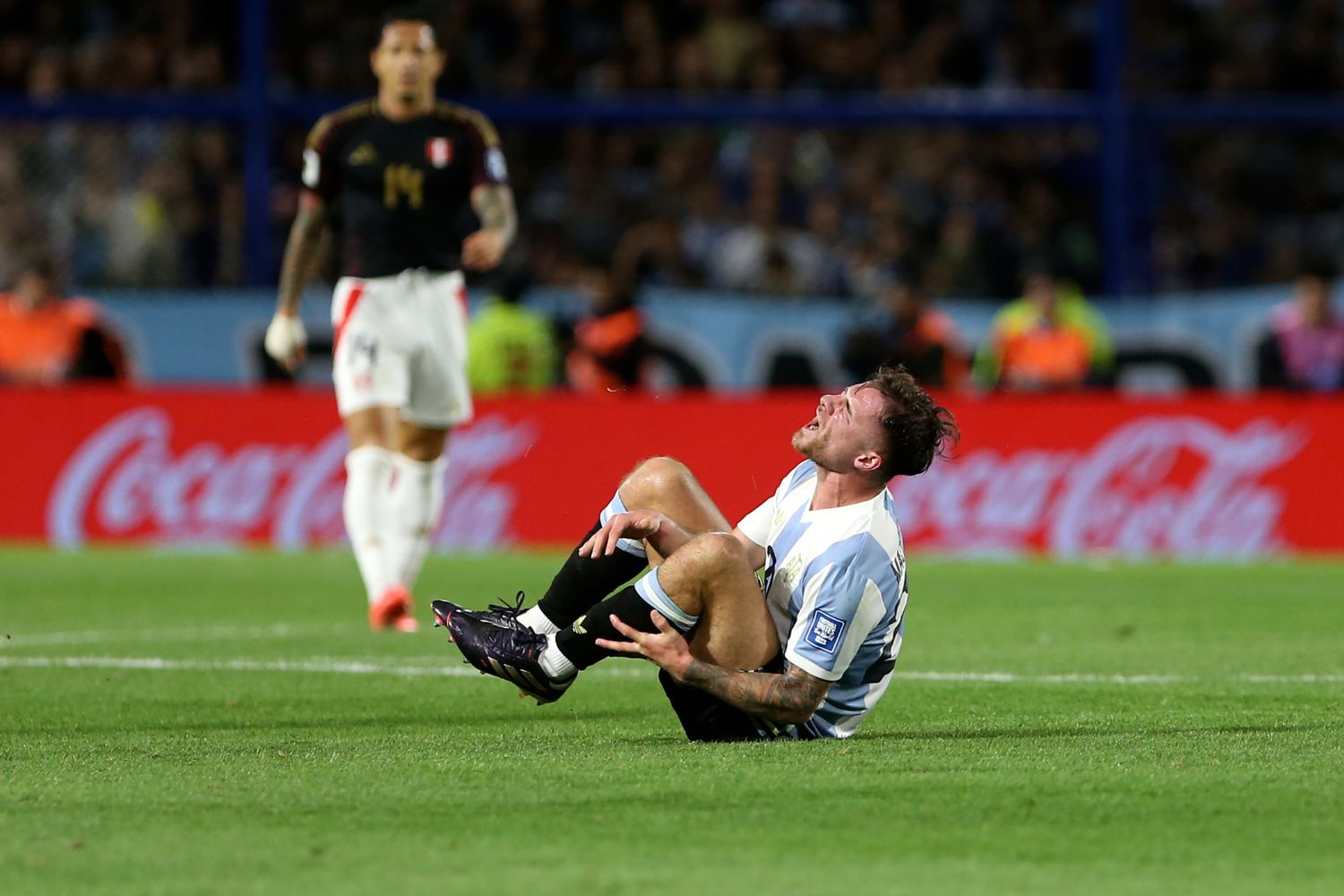 Alexis Mac Allister lays injured on the floor for Argentina