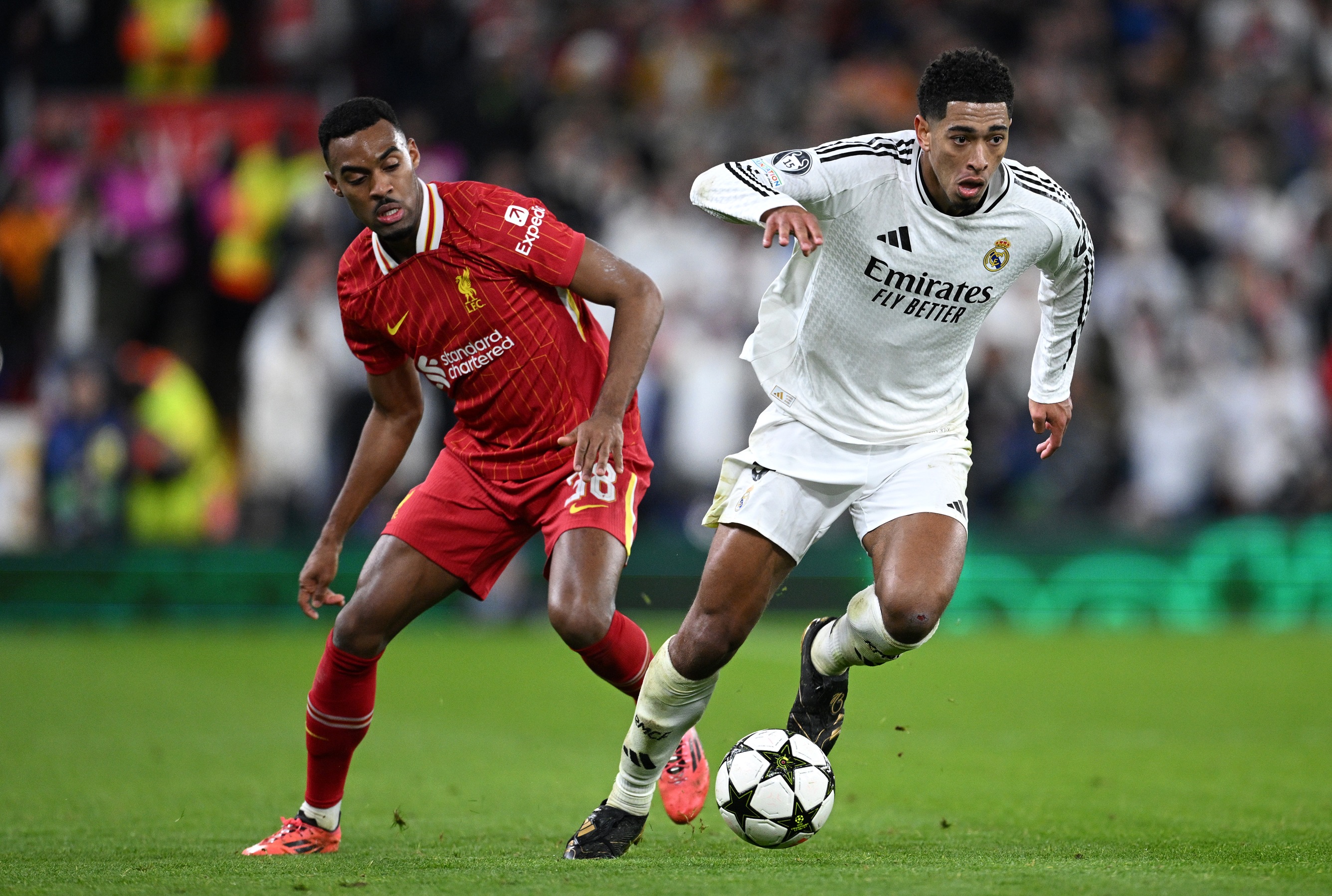 Real Madrid star Jude Bellingham competes for the ball with Liverpool F.C. star Ryan Gravenberch.