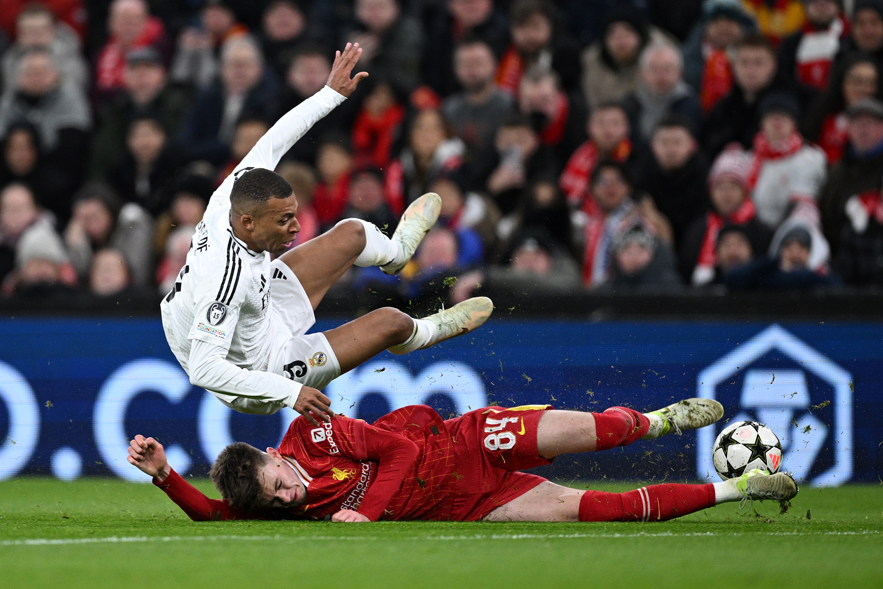 Curtis Jones tackles Kylian Mbappe during Liverpool v Real Madrid.