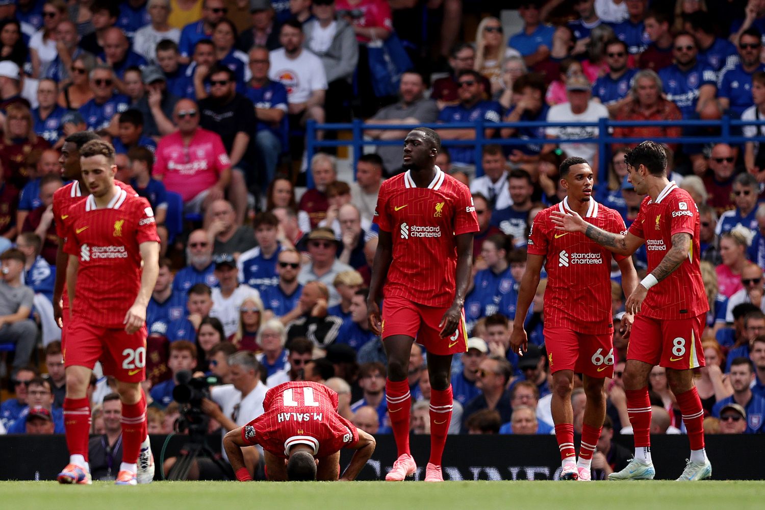 Ibou Konate watches on as Mo Salah celebrates scoring