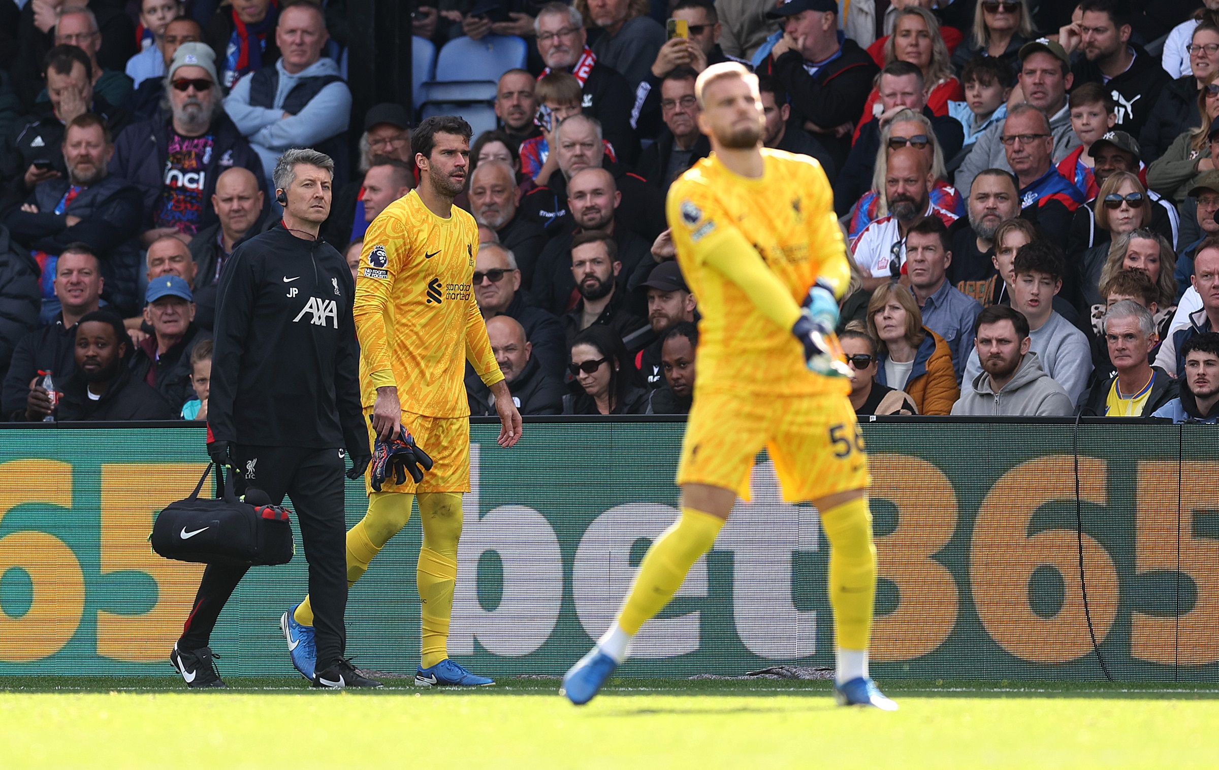 Alisson Becker walks off the pitch after picking up a hamstring injury.