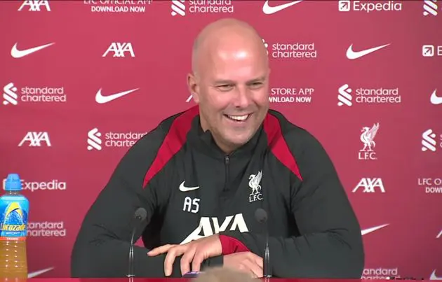 A smiling Arne Slot addresses the media.