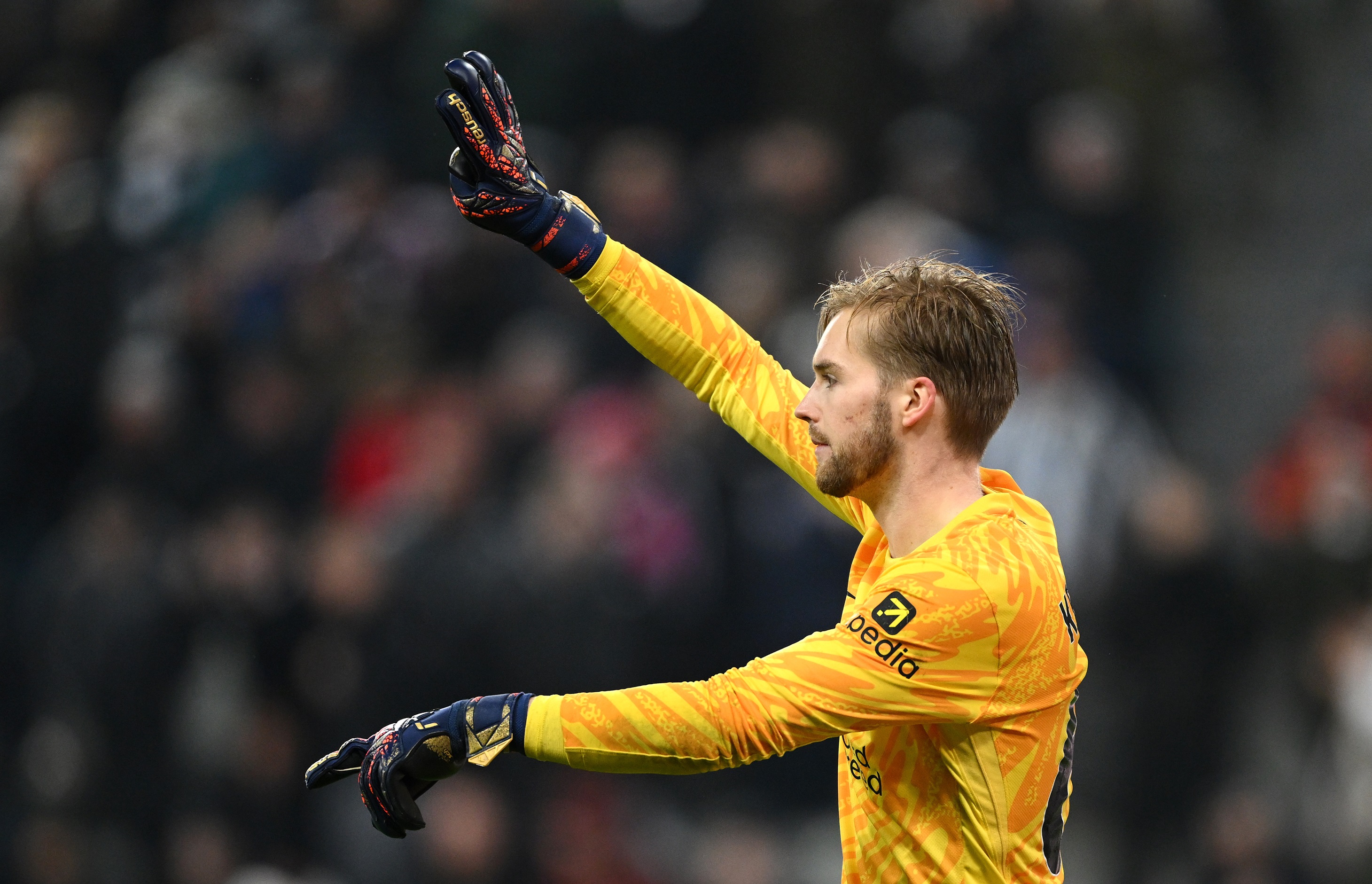 Caoimhin Kelleher signals to Liverpool teammates during Newcastle game.