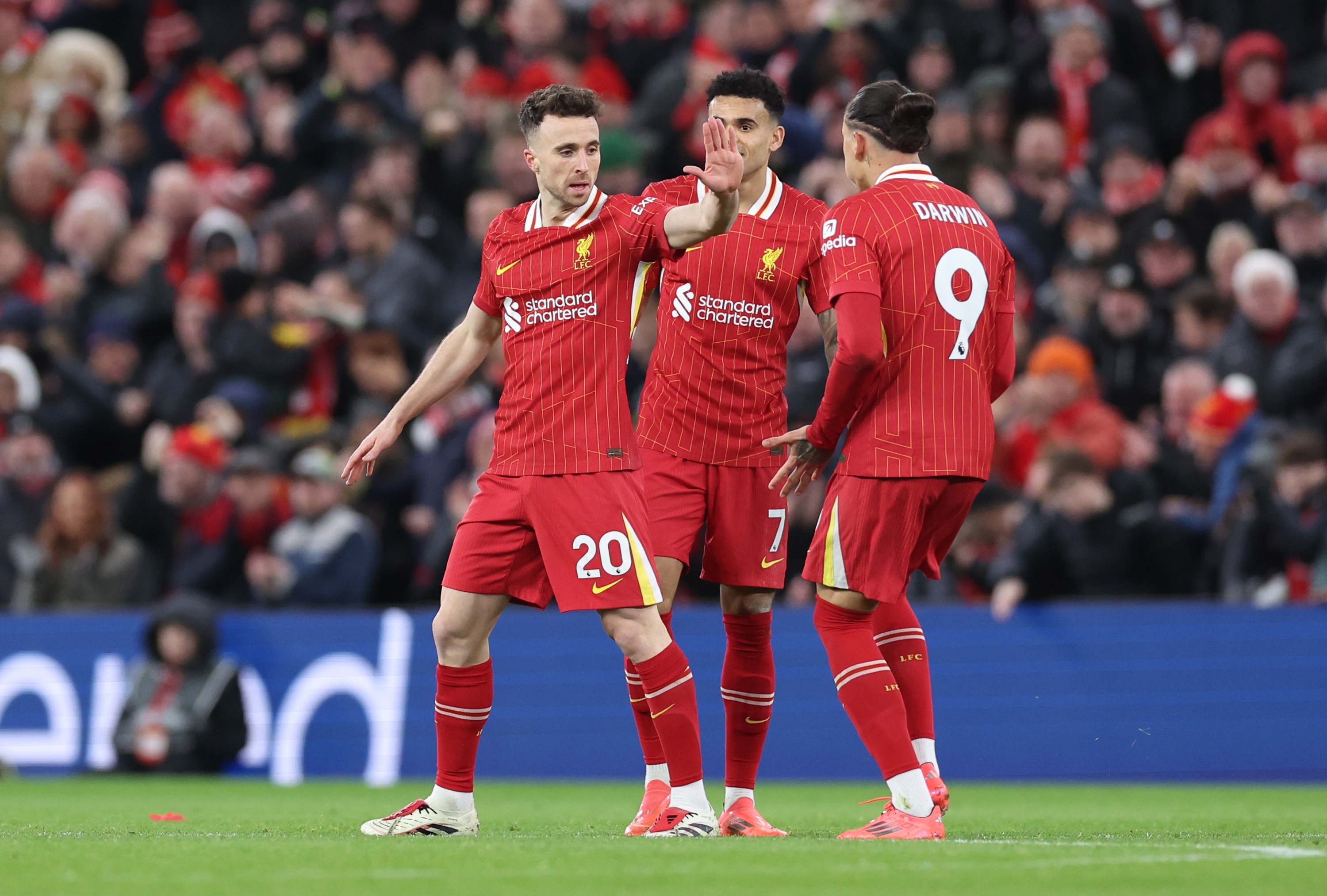 Darwin Nunez celebrates with Diogo Jota after providing an assist at Anfield.