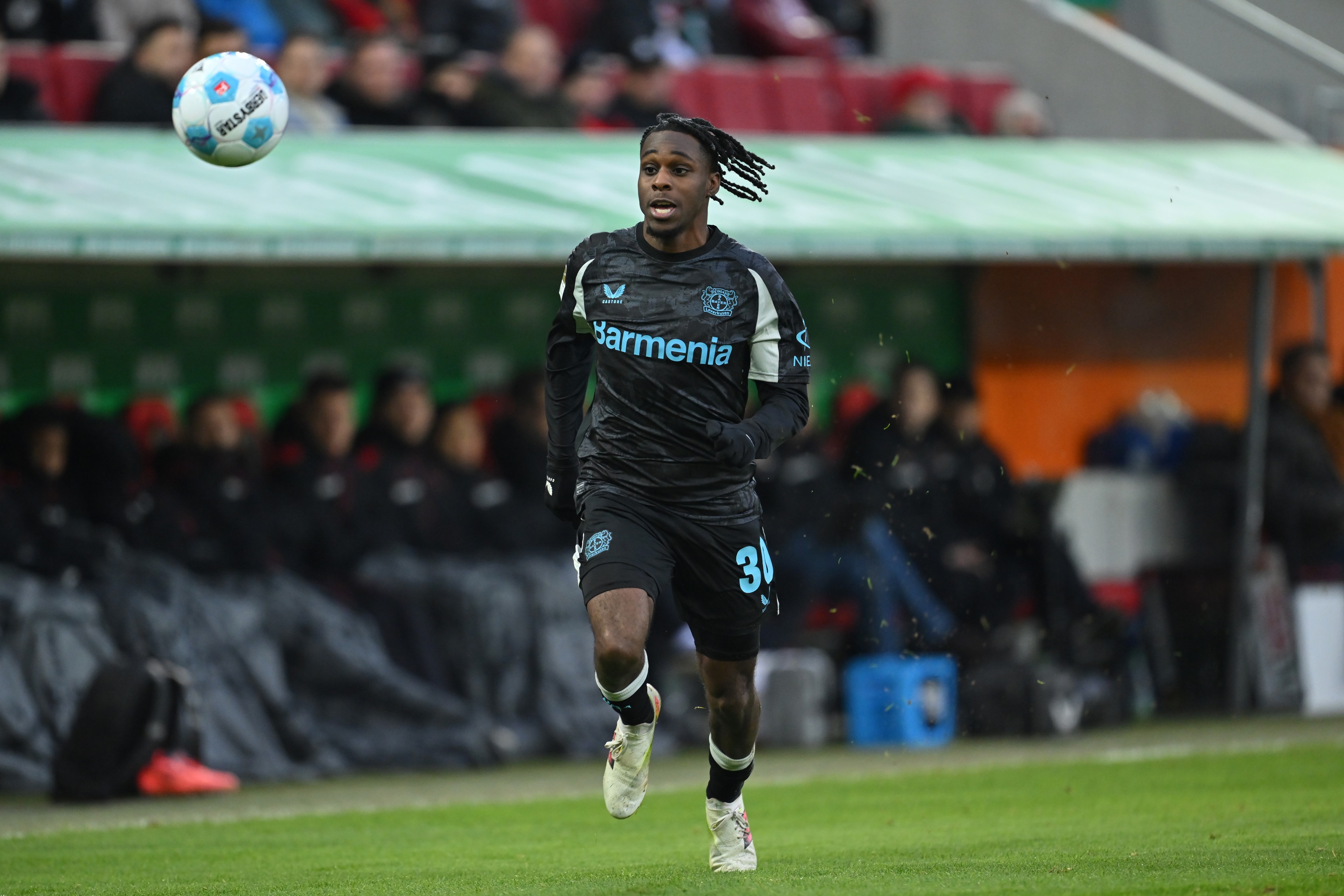 Jeremie Frimpong chases after the ball during Bayer Leverkusen game.