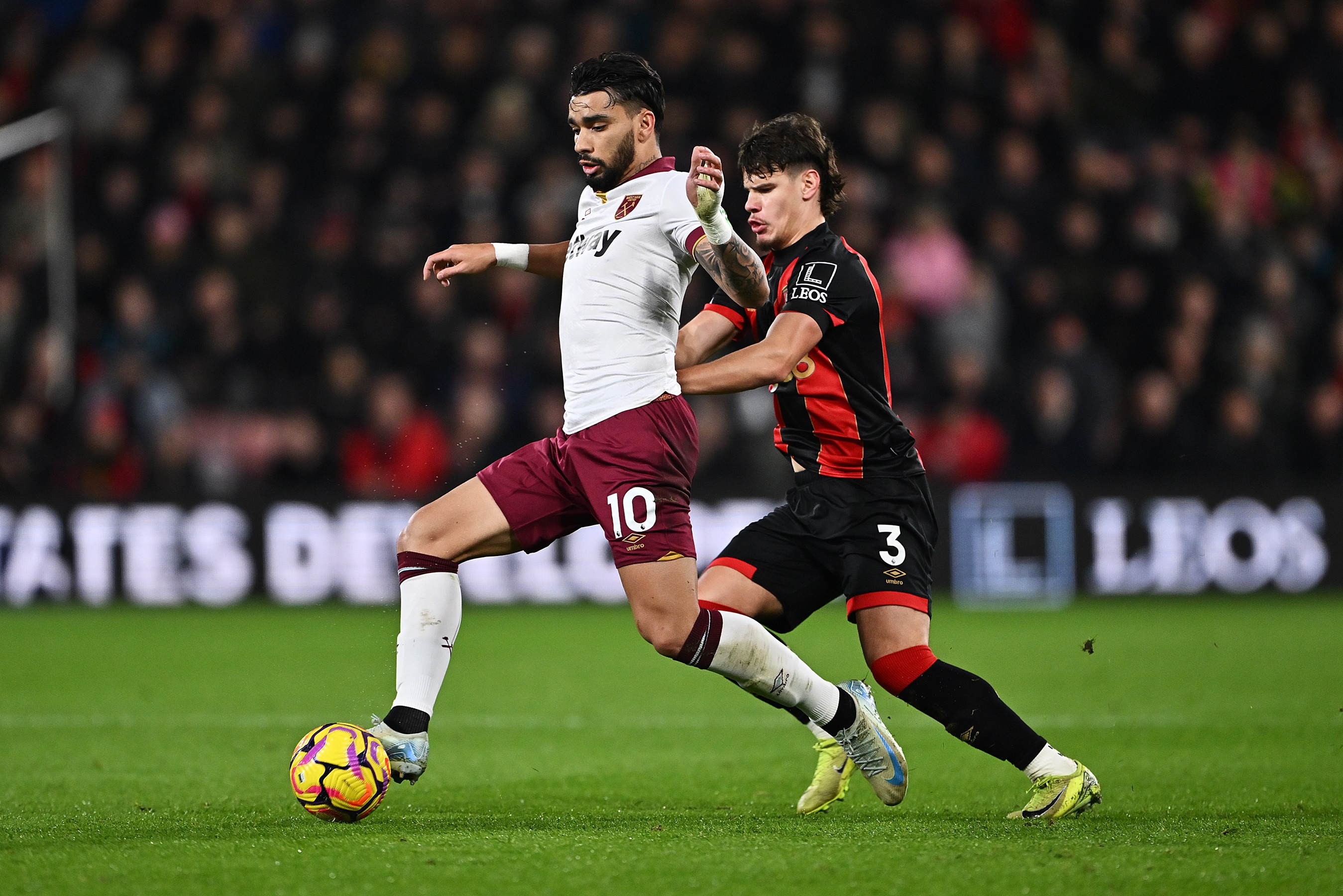 Milos Kerkez attempts to win the ball off Lucas Paqueta at the Vitality Stadium.