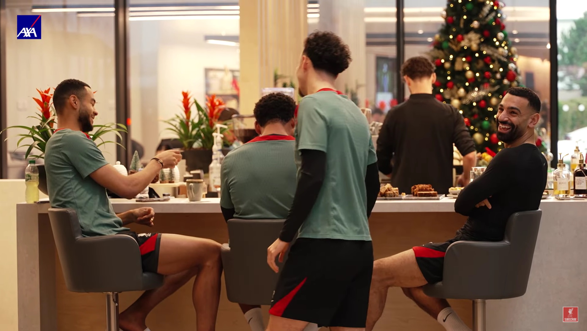 Mo Salah smiling at Liverpool's coffee bar in the AXA training centre.