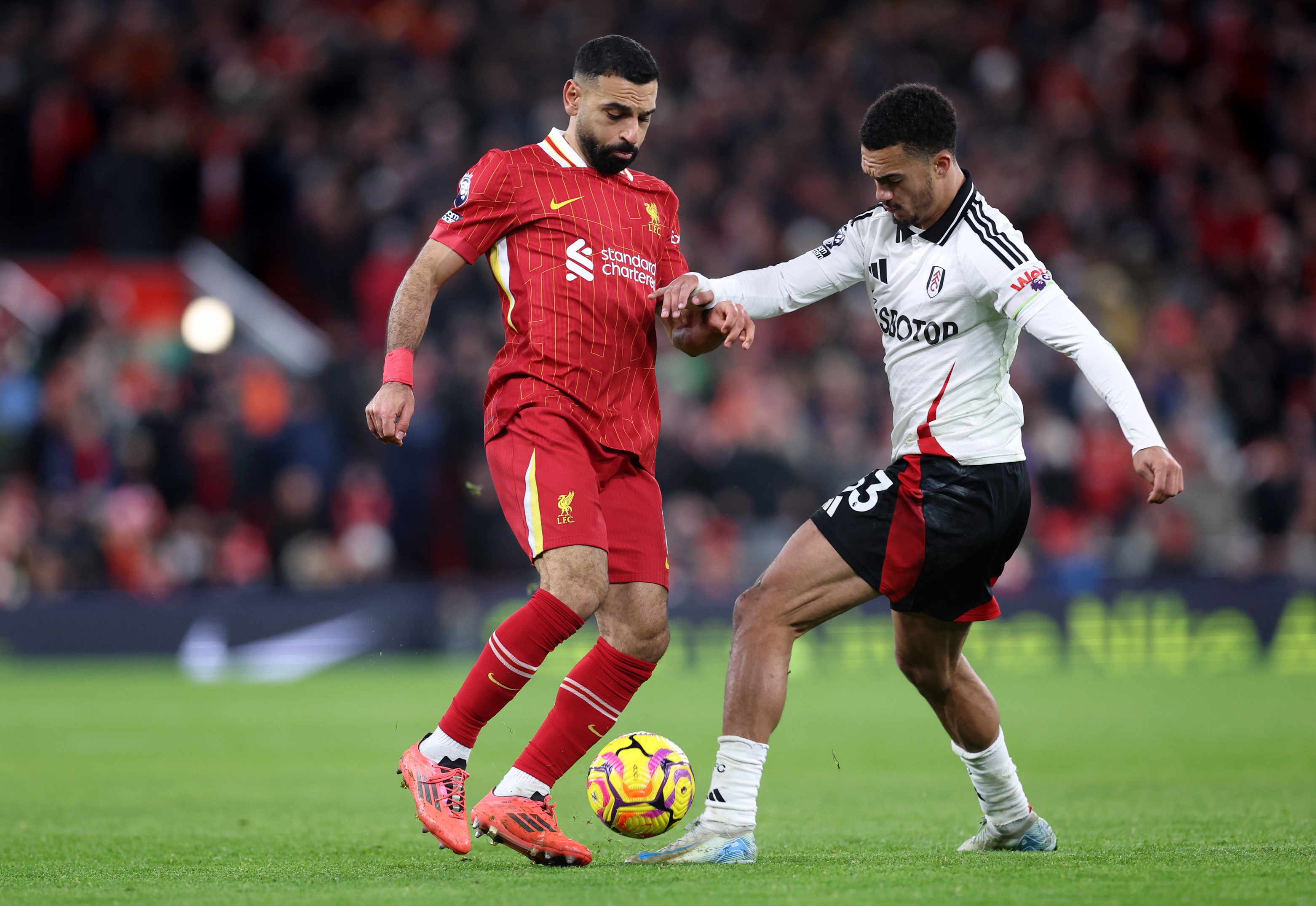 Mo Salah attempts to dribble past Fulham's Antonee Robinson at Anfield.