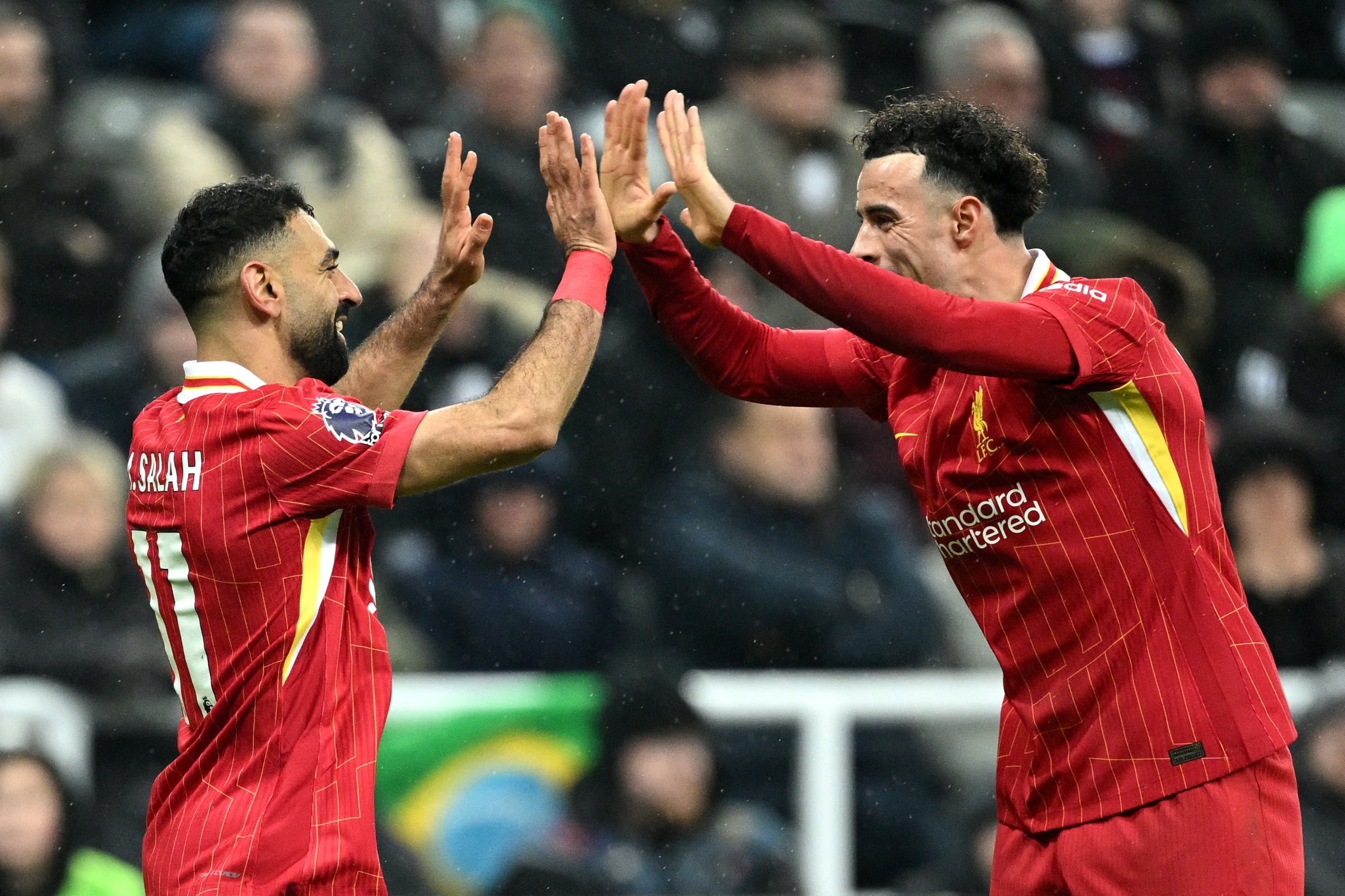 Mo Salah celebrates scoring against Newcastle with Curtis Jones.