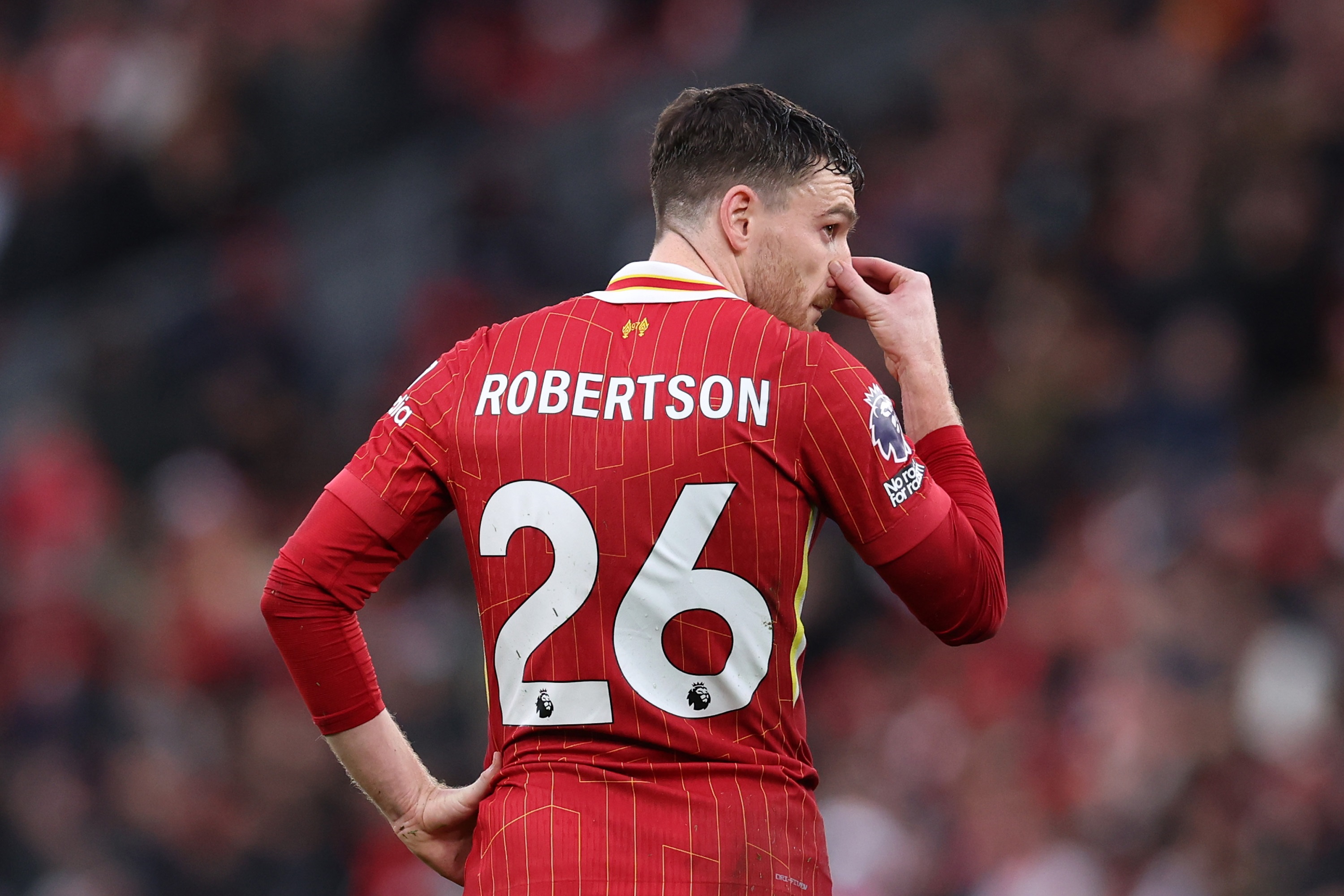 Andy Robertson reacts to receiving a red card against Fulham at Anfield.