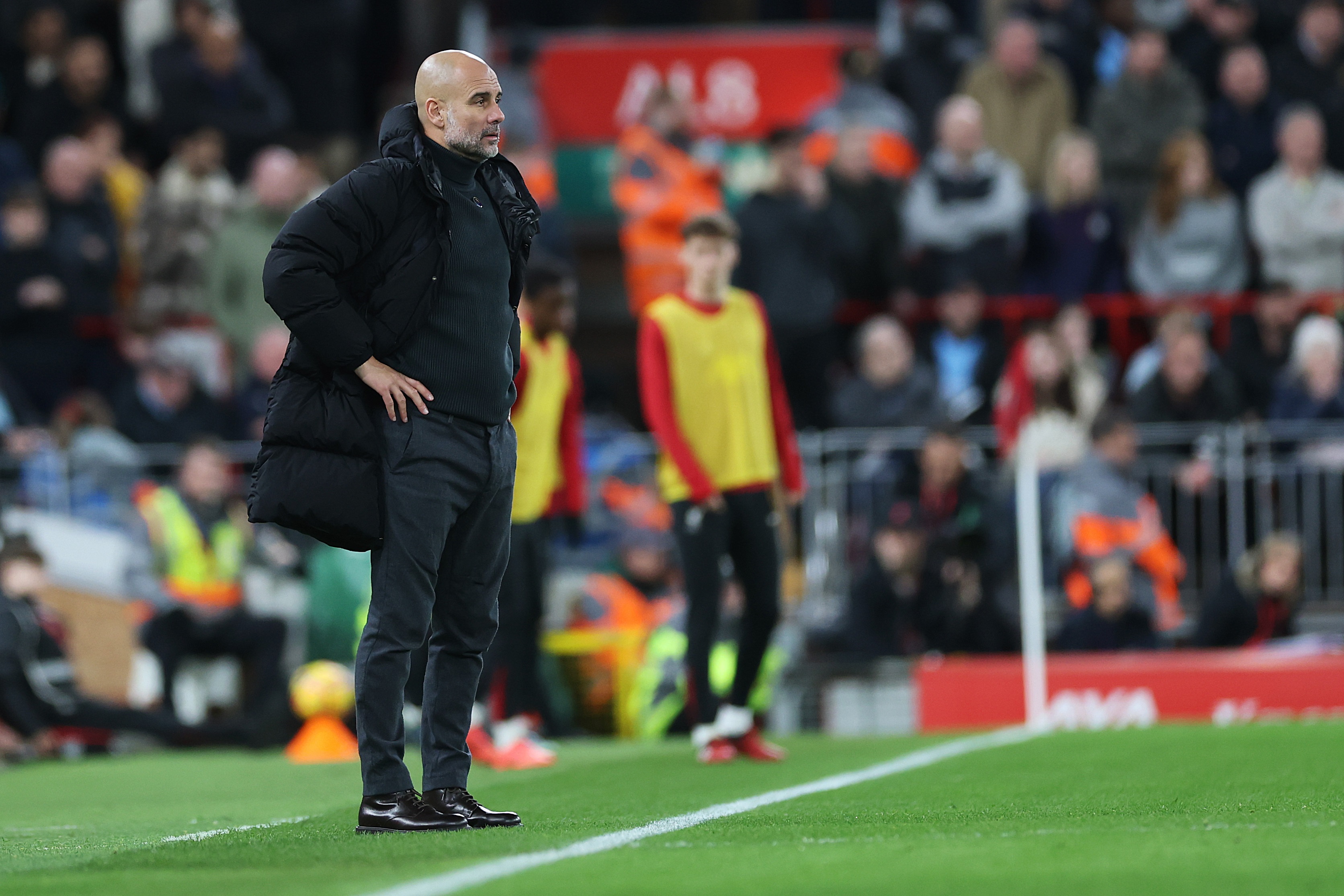 Pep Guardiola observes the game between Liverpool and Man City.