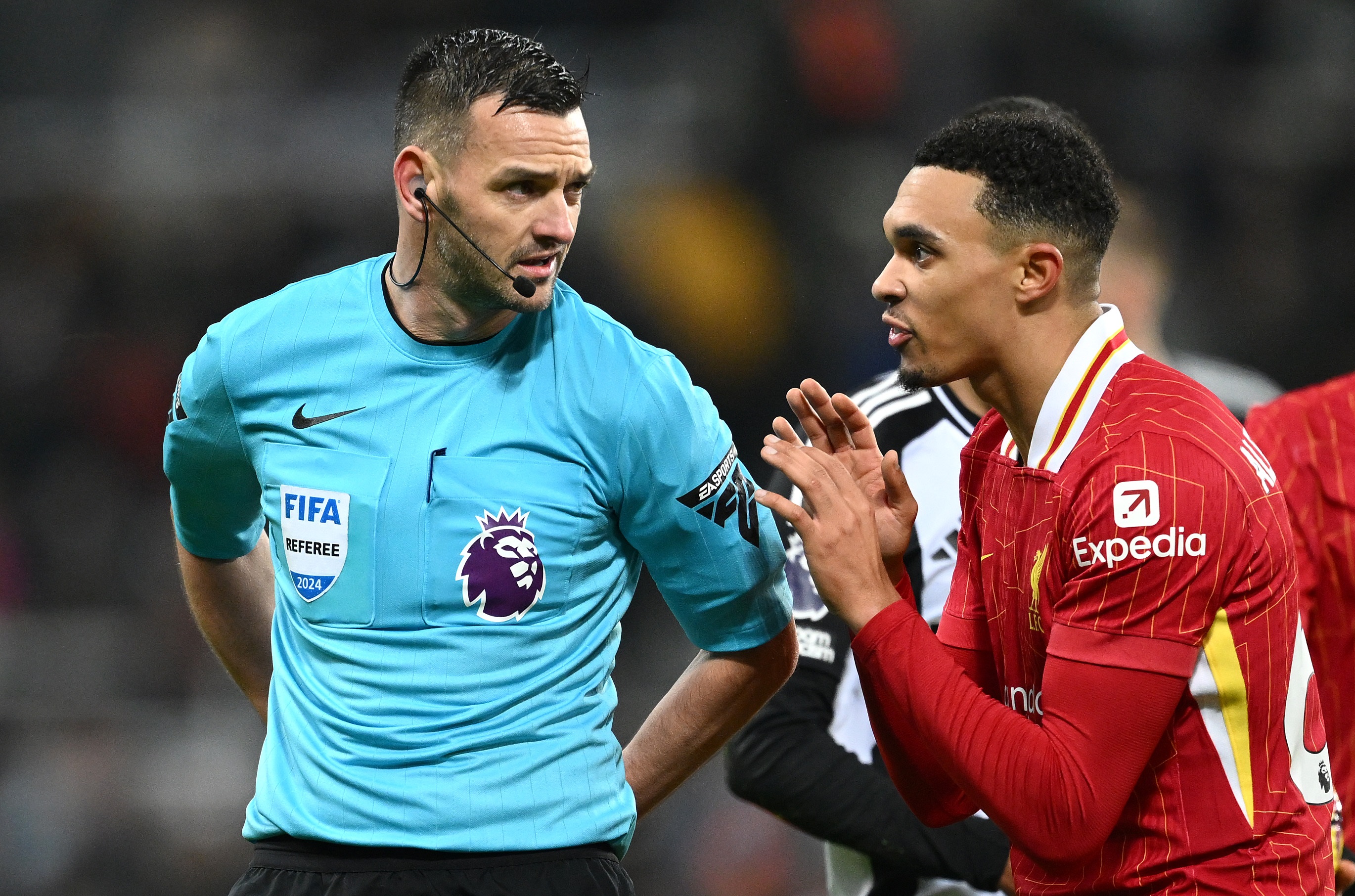 Trent Alexander-Arnold talks with referee Andy Madley.