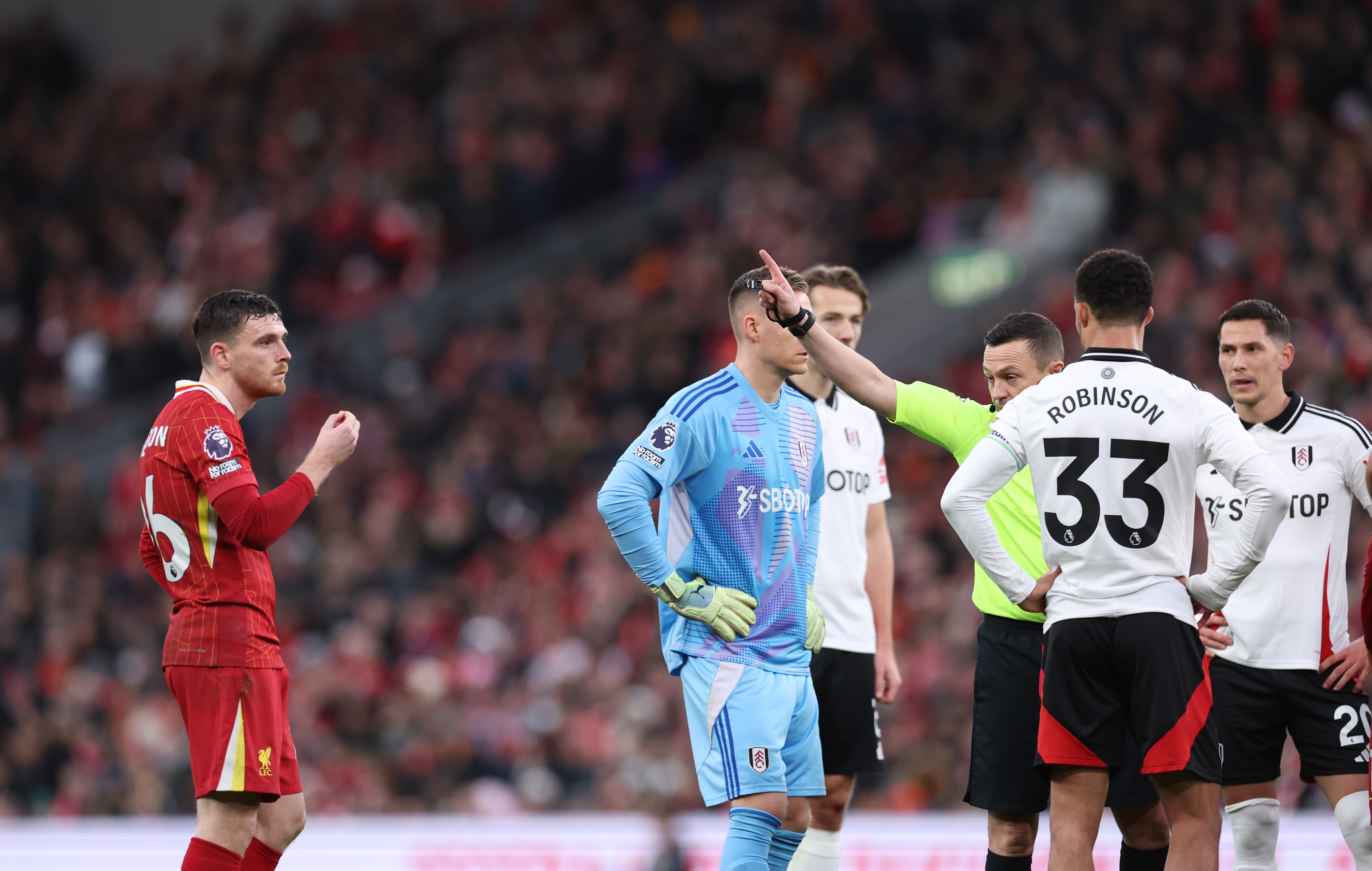 Andy Robertson reacts to being shown a red card against Fulham.