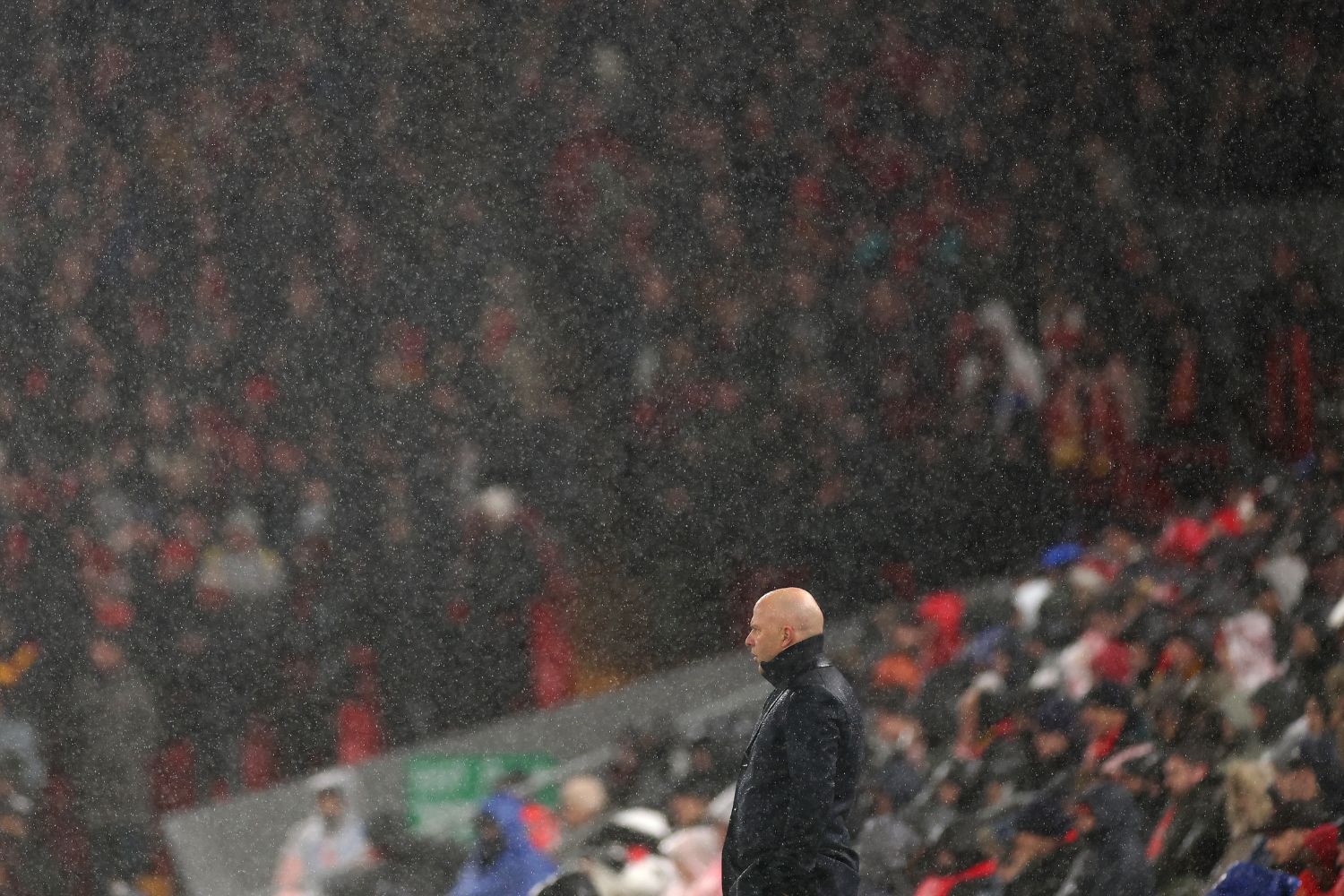 Arne Slot watches Liverpool in the rain