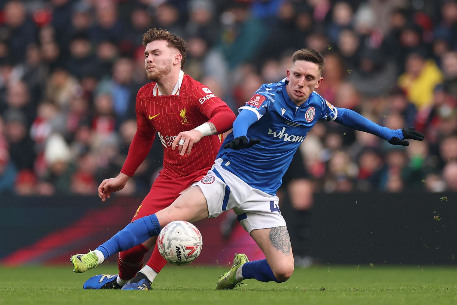 Harvey Elliott of Liverpool clashes with Ashley Hunter of Accrington Stanley