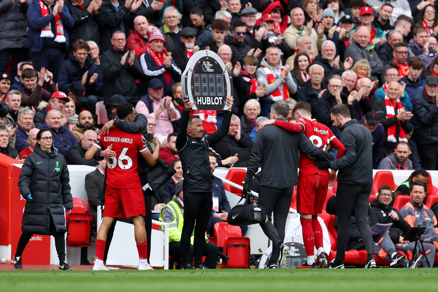 Conor Bradley of Liverpool leaves the pitch injured as Trent Alexander-Arnold of Liverpool is embraced by Jurgen Klopp