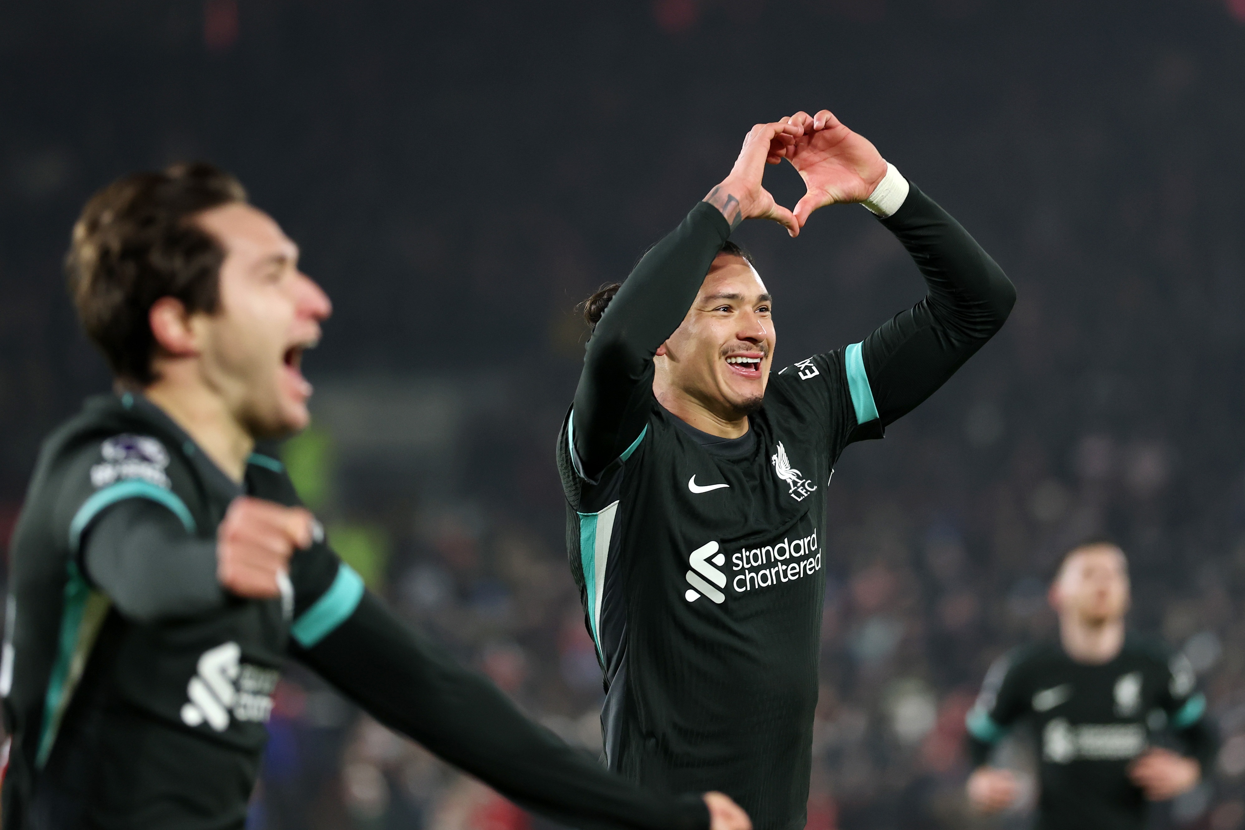 Darwin Nunez holds up a heart sign to Liverpool fans at Brentford.