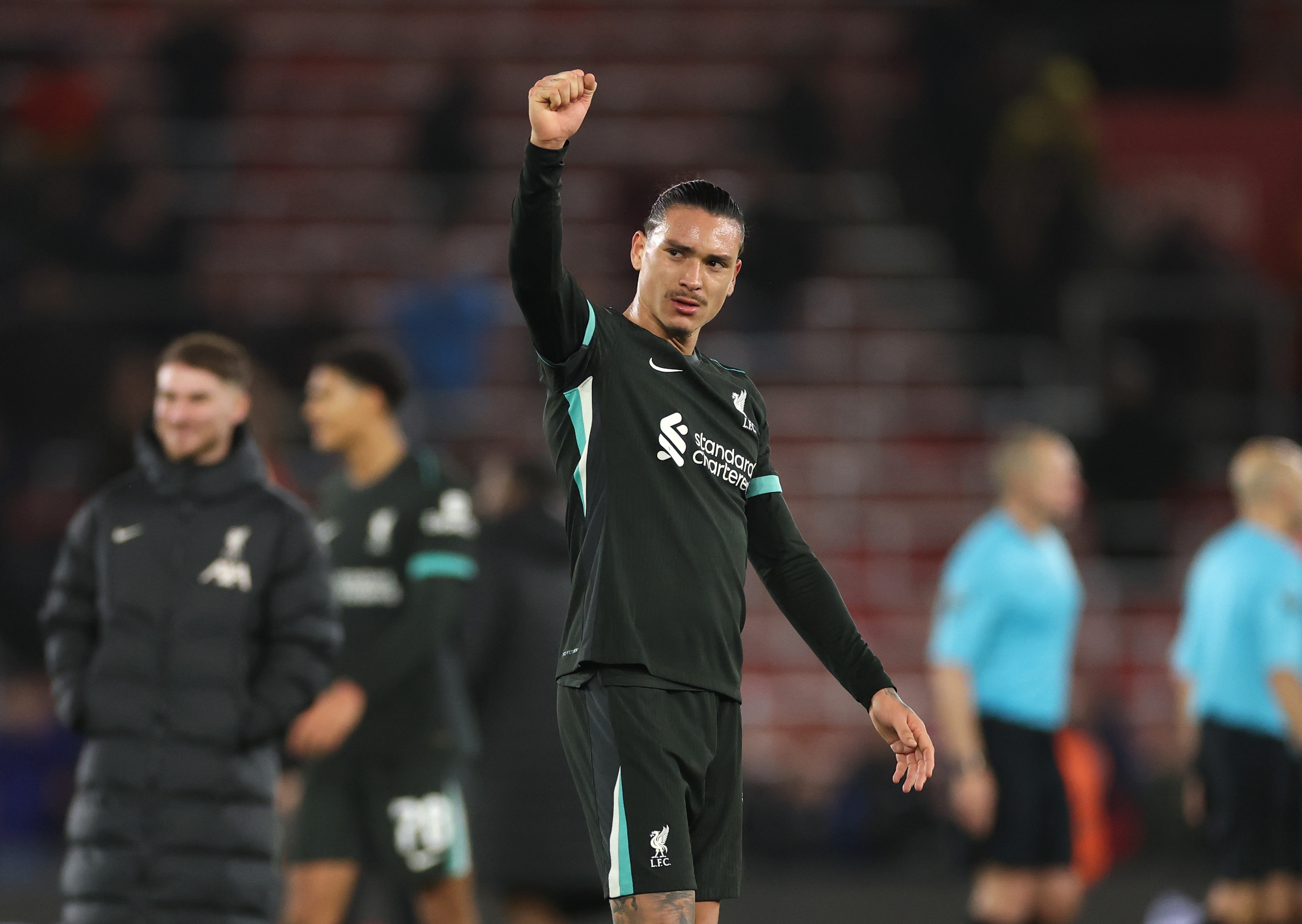 Darwin Nunez raises his fist to Liverpool fans during a Carabao Cup game.