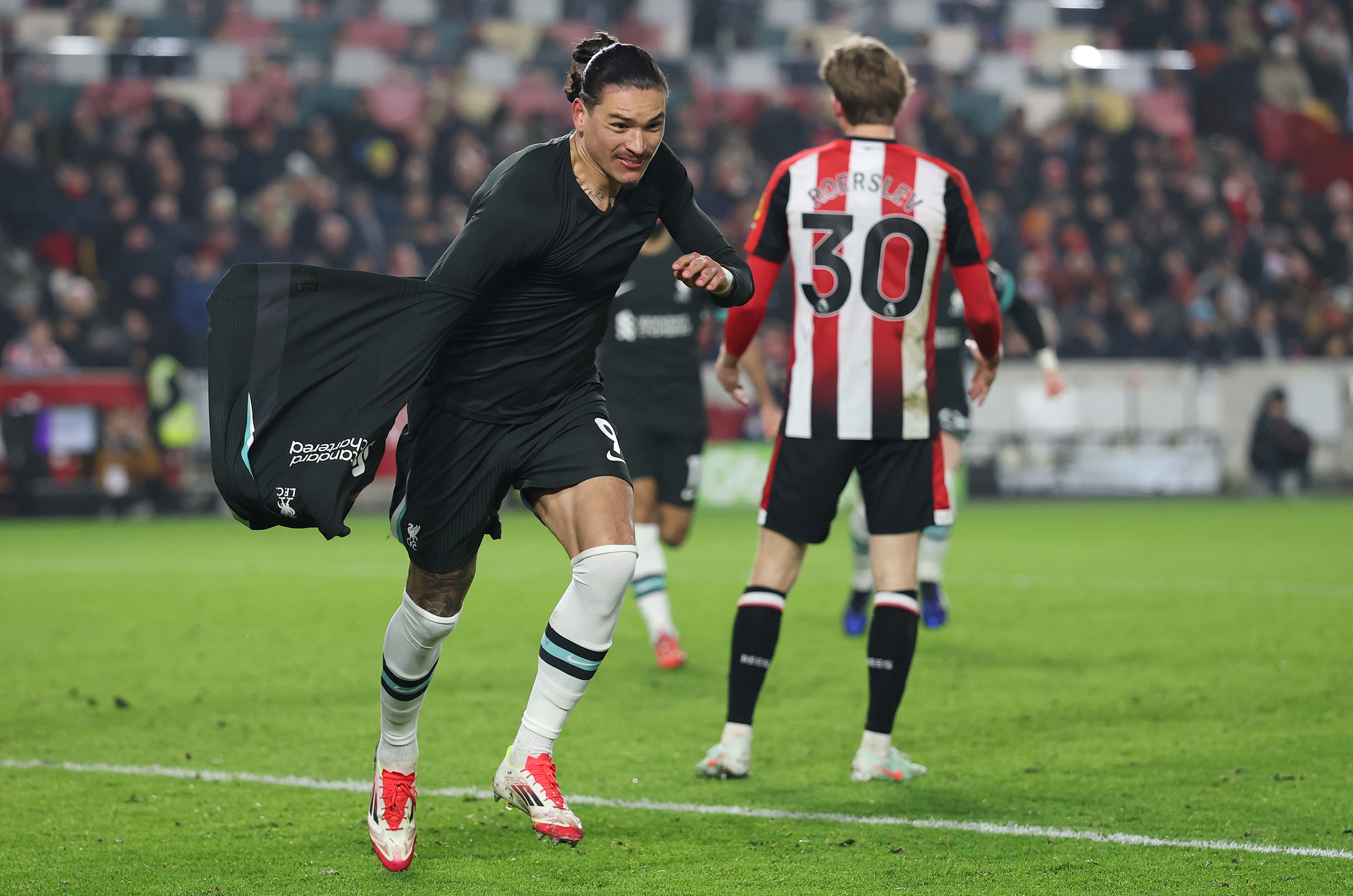 Darwin Nunez takes off his shirt after scoring against Brentford.
