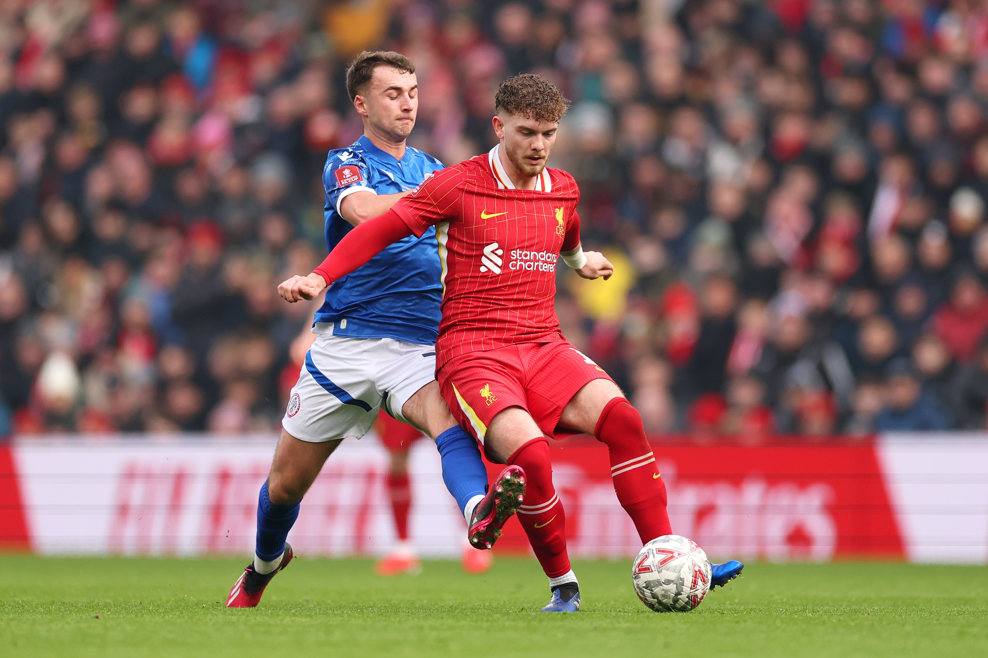 Harvey Elliott holds on to the ball under pressure at Anfield.