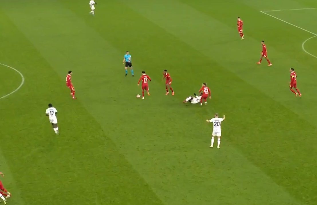 Curtis Jones moves with the ball after Kostas Tsimikas tackle.