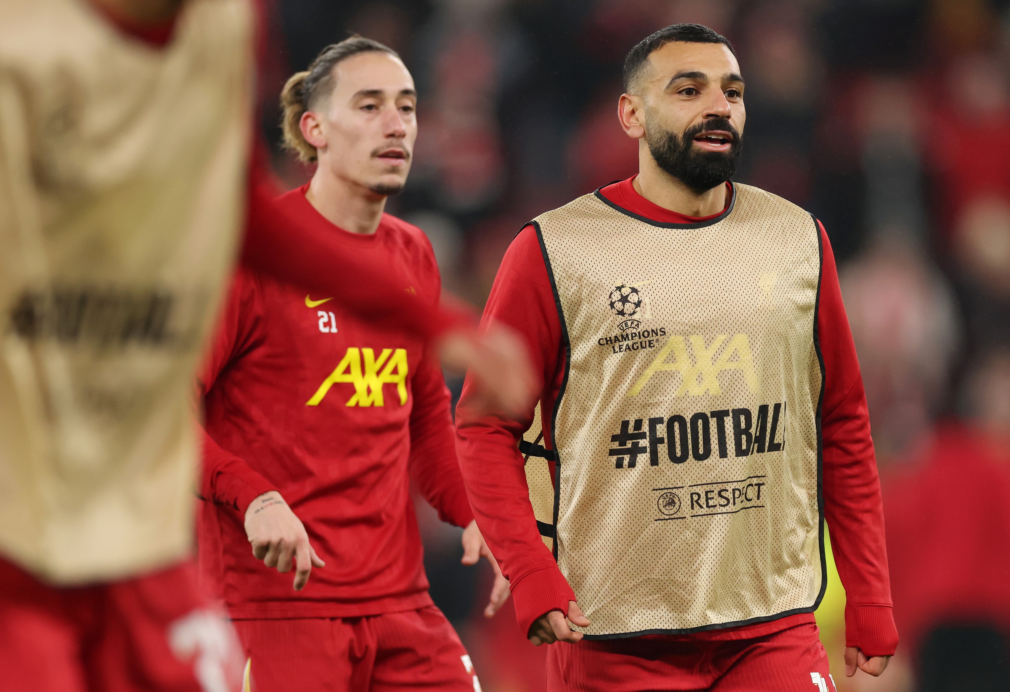 Kostas Tsimikas warms up with Mo Salah ahead of Lille game.