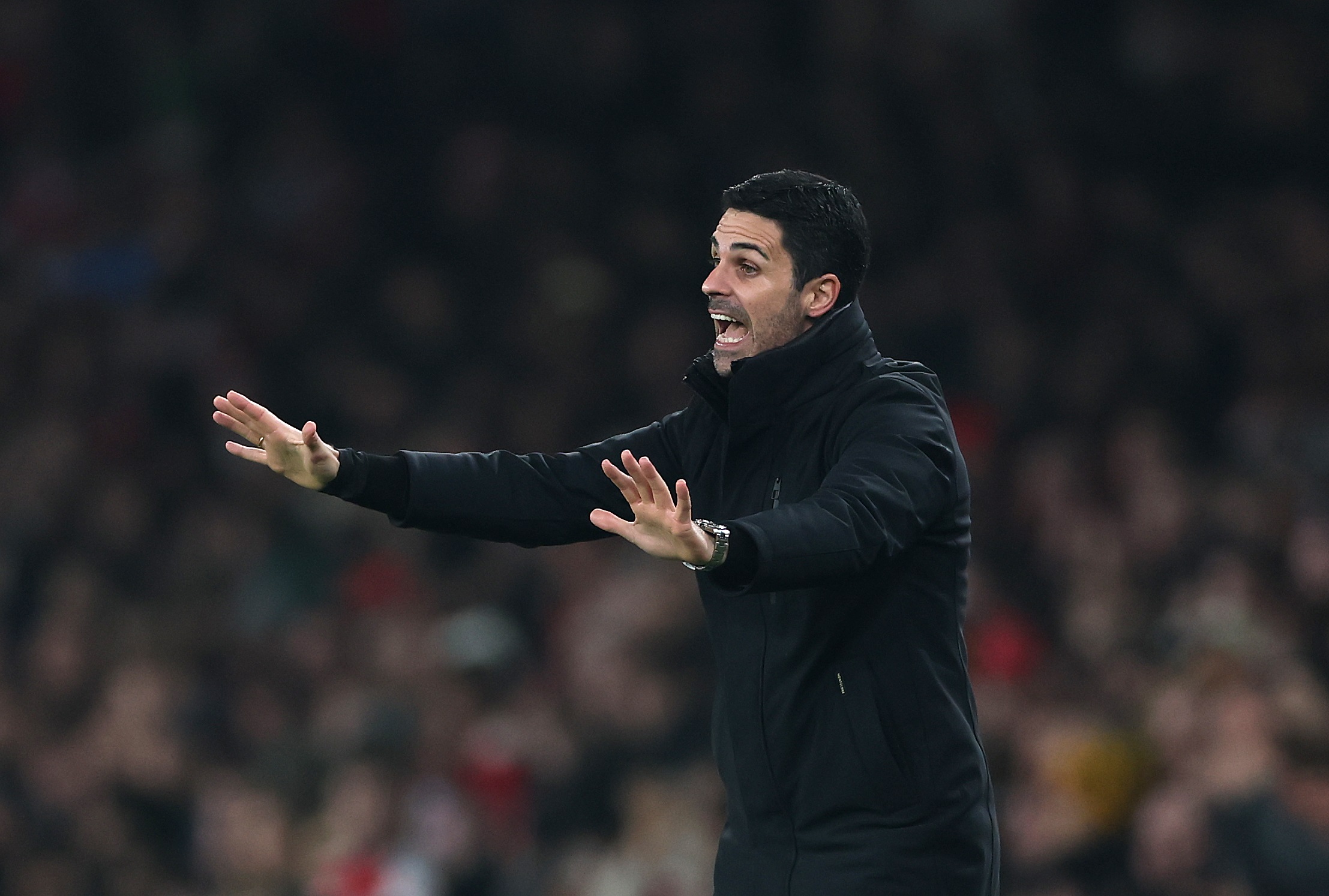 Mikel Arteta gestures to his Arsenal players on the pitch.