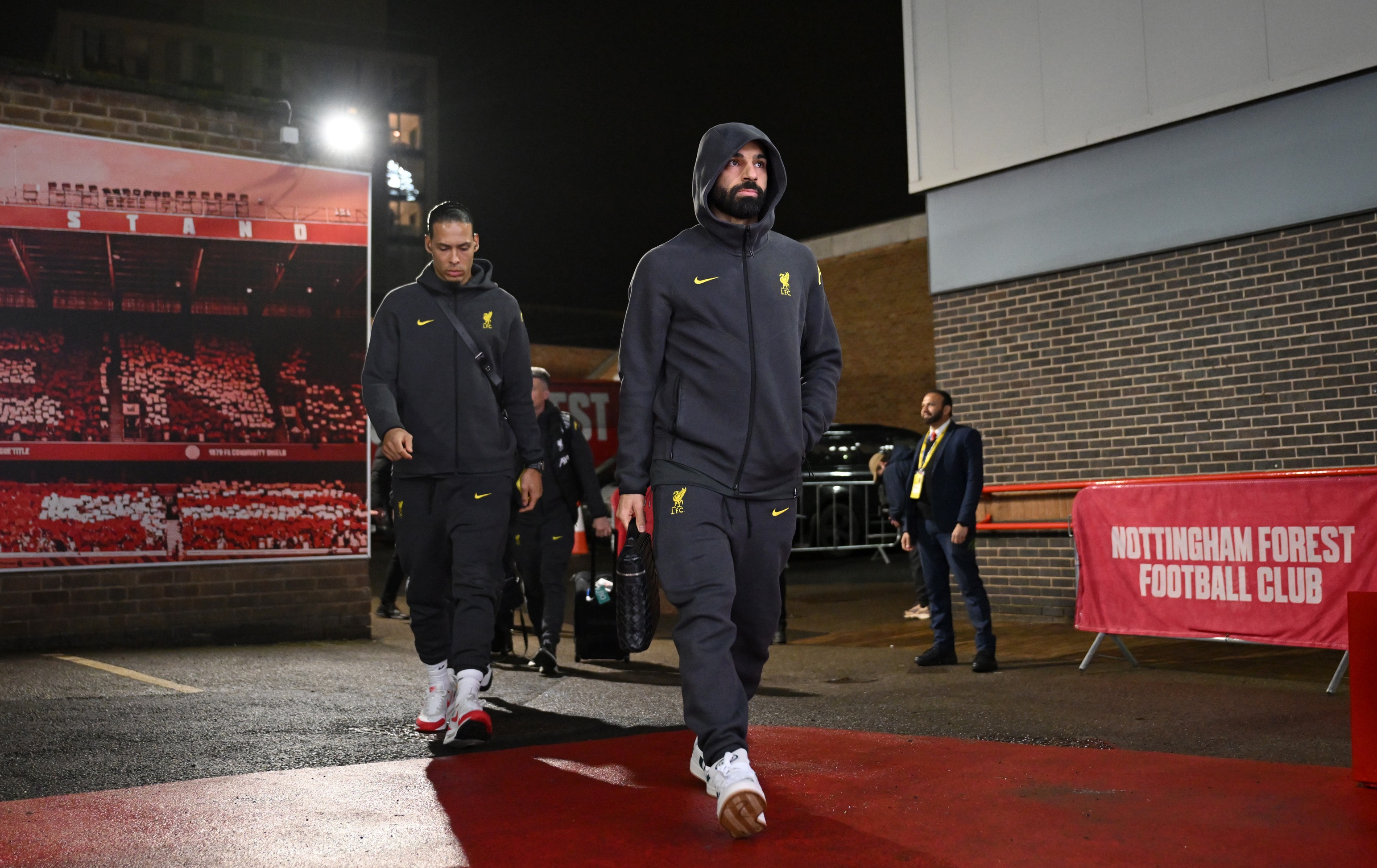 Mo Salah walks into the City Ground with Virgil van Dijk behind him.