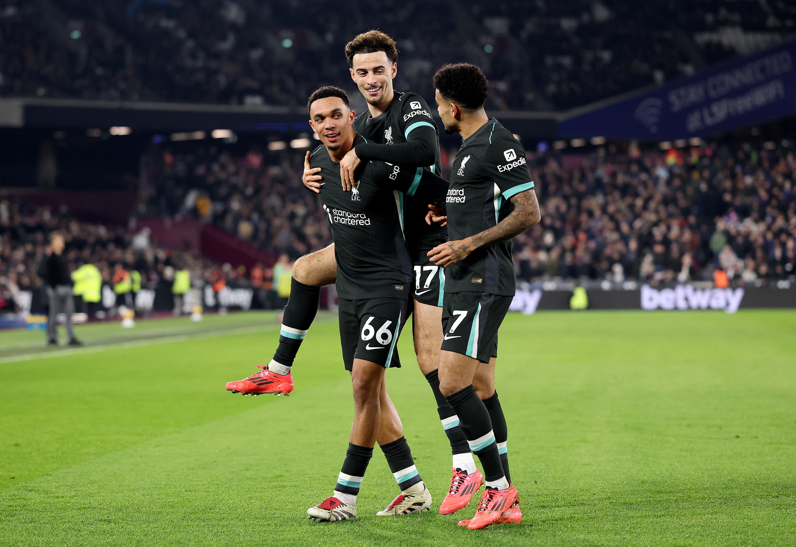 Trent Alexander-Arnold celebrates with Curtis Jones and Luis Diaz after scoring against West Ham in London.