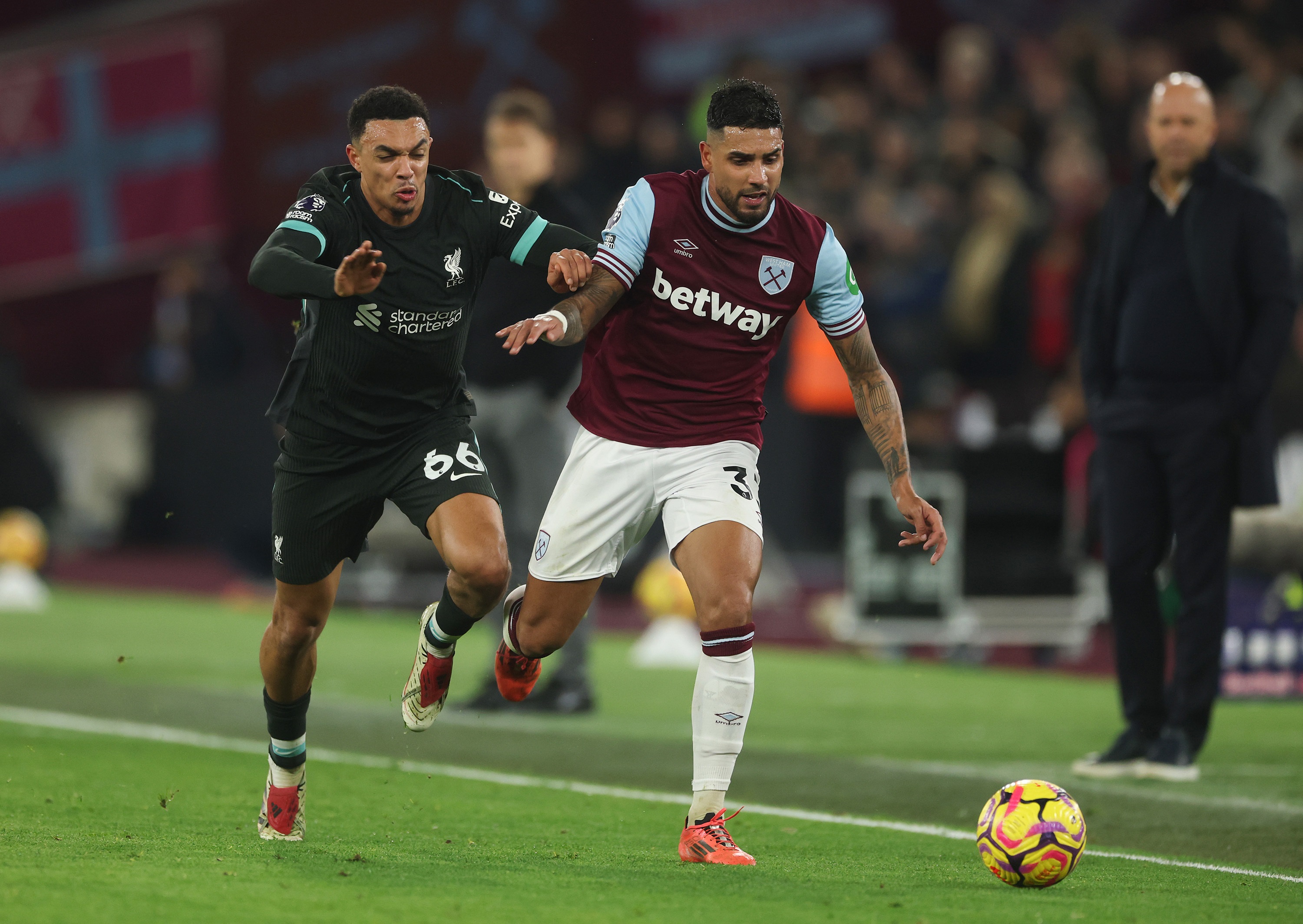 Trent Alexander-Arnold fights to win the ball against West Ham's Emerson Palmieri.