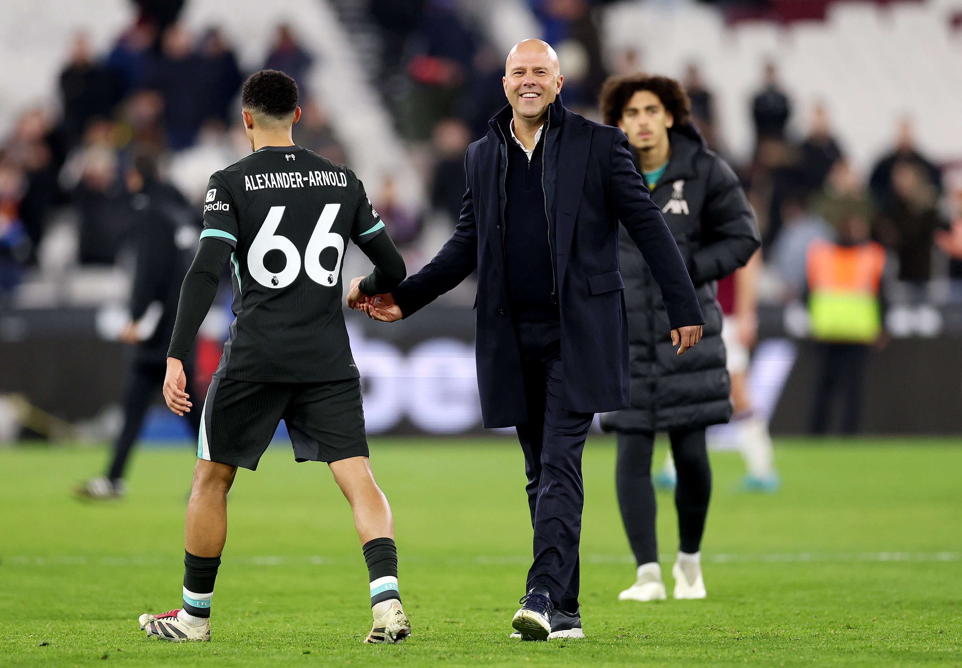 Trent Alexander-Arnold shakes Liverpool head coach Arne Slot's hand in London.