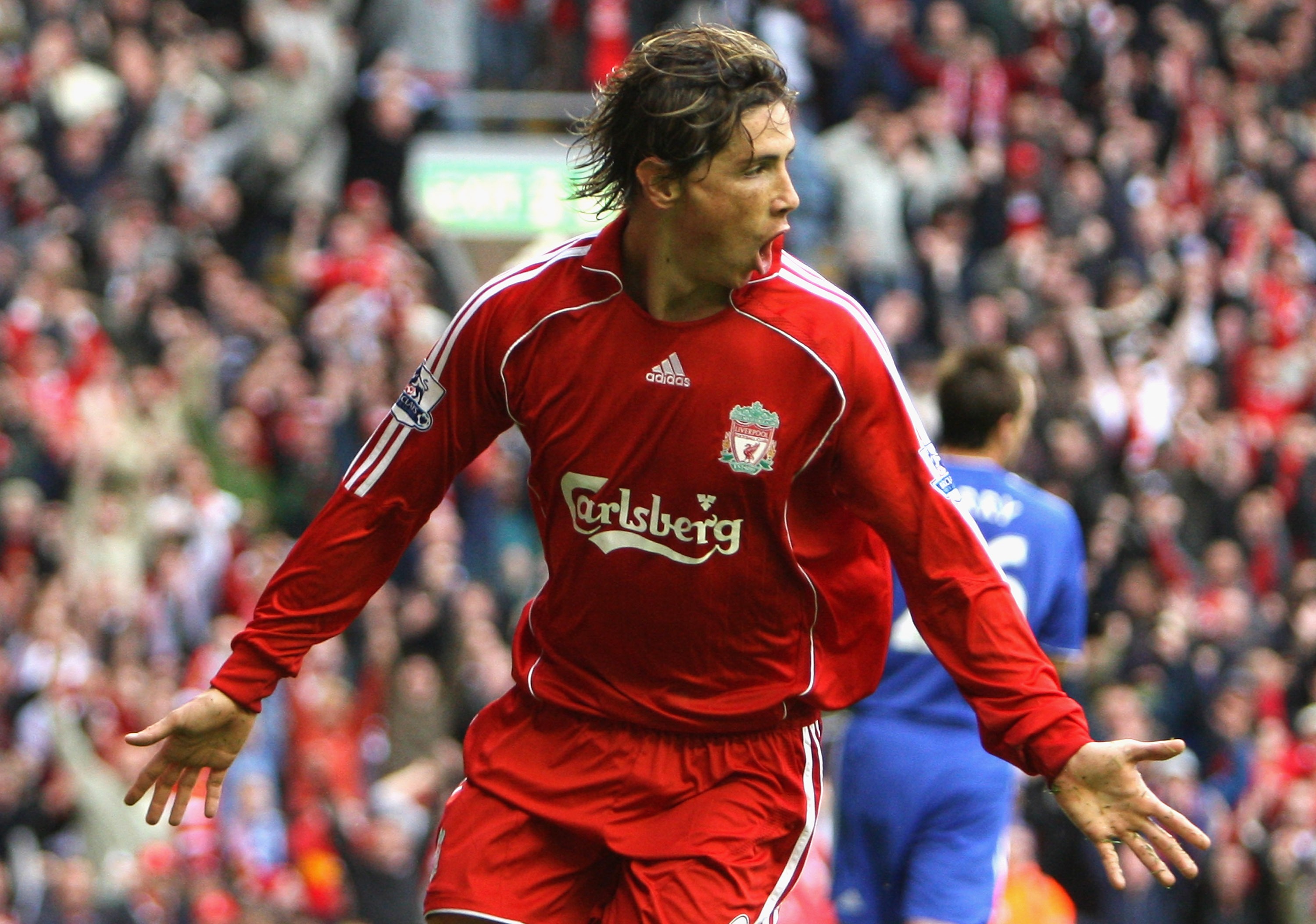 Fernando Torres celebrates scoring in a legendary Liverpool shirt