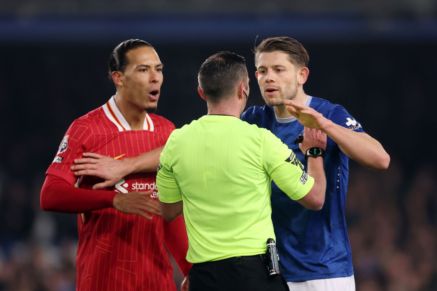 Virgil van Dijk and James Tarkowski speak with Michael Oliver