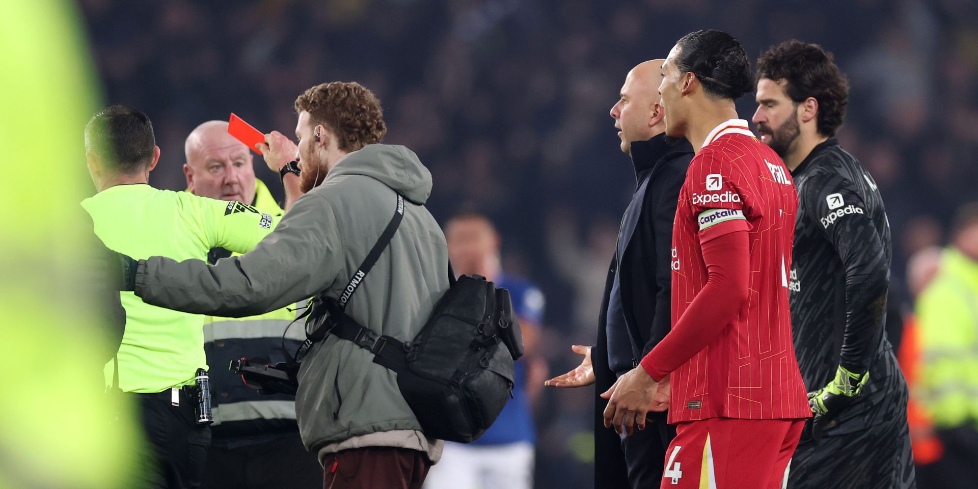 Virgil van Dijk and Arne Slot see a red card issued by Michael Oliver