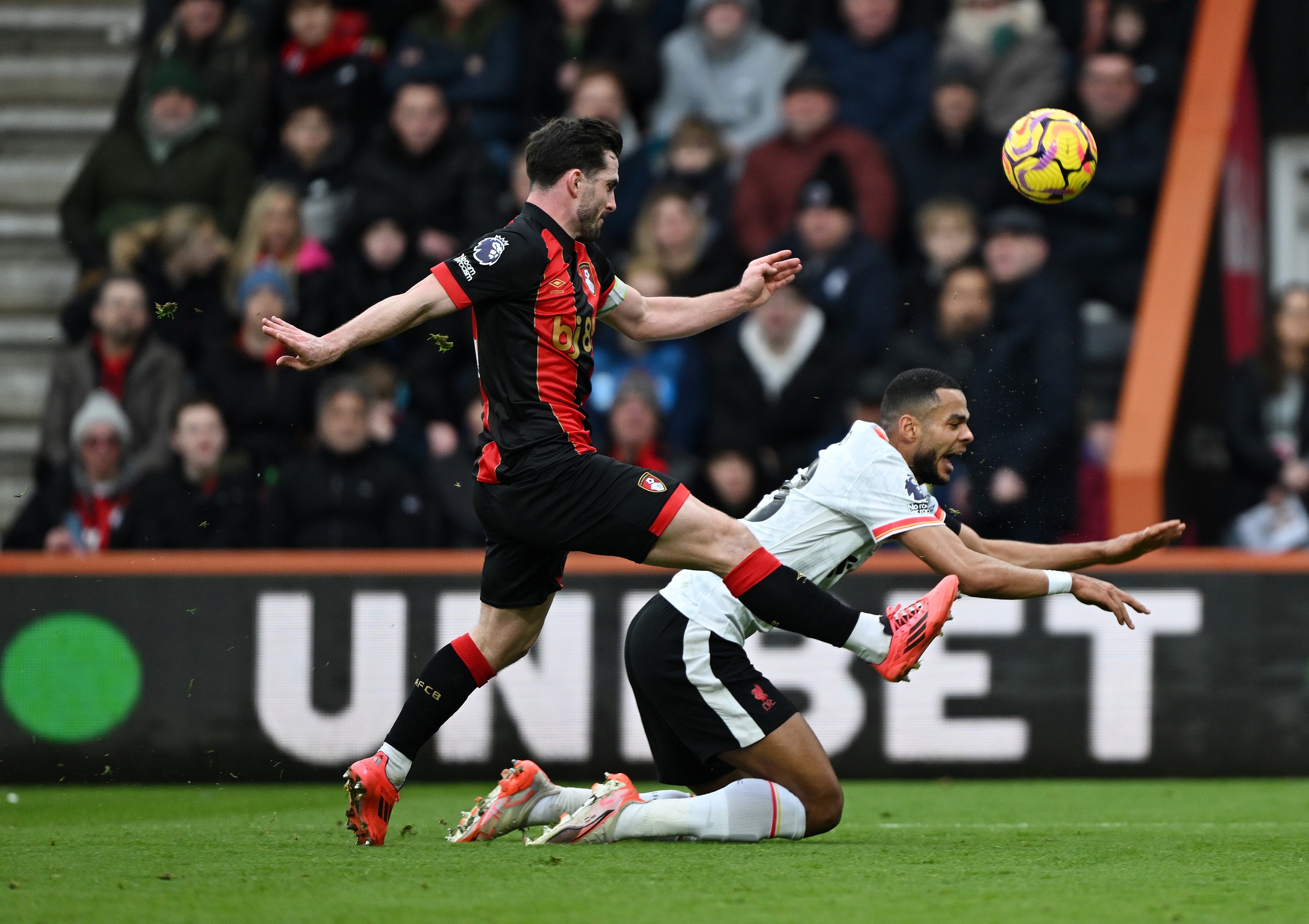 Lewis Cook trips up Cody Gakpo in the Bournemouth box.