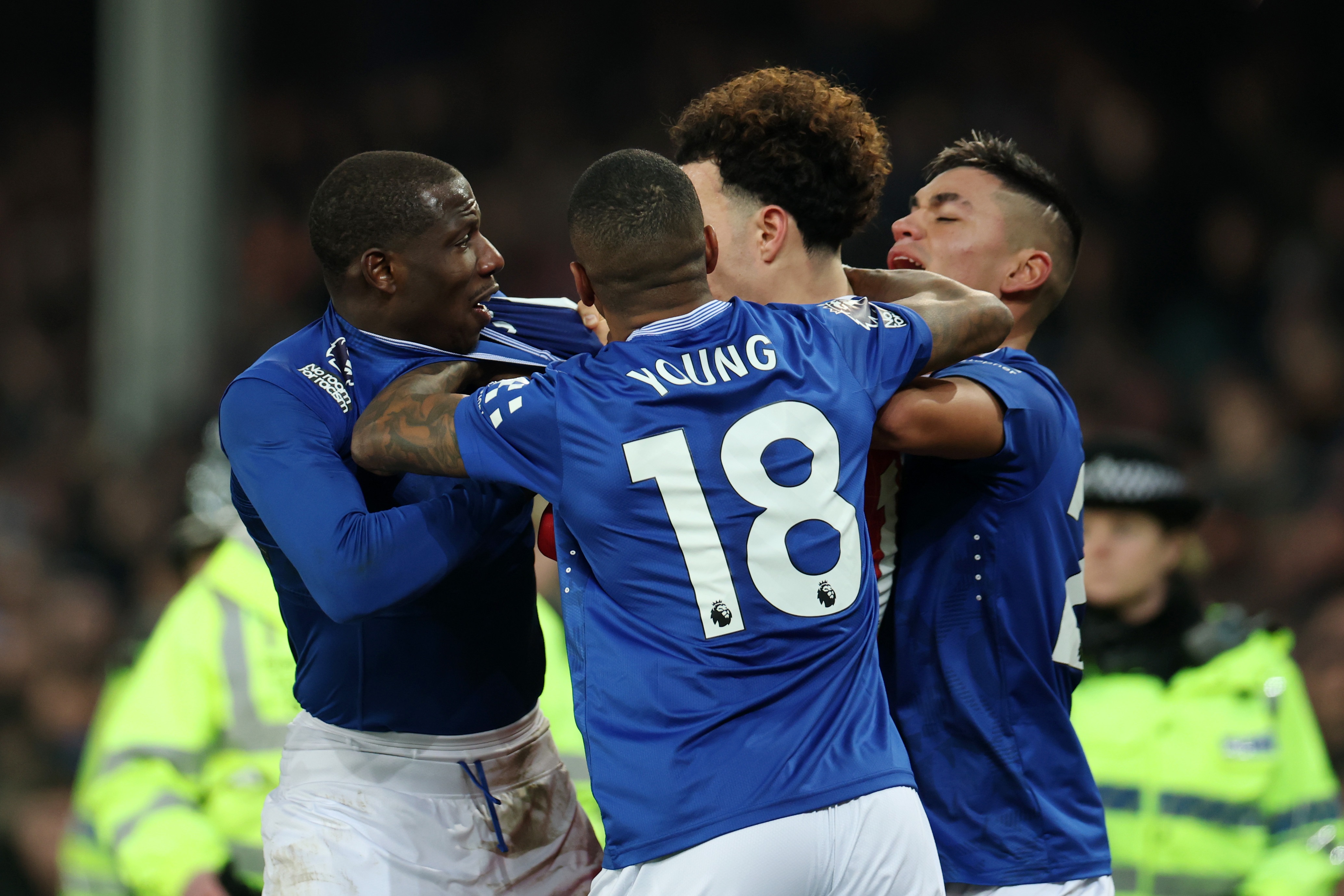 Curtis Jones gets in a scrap with Doucoure at Goodison Park.