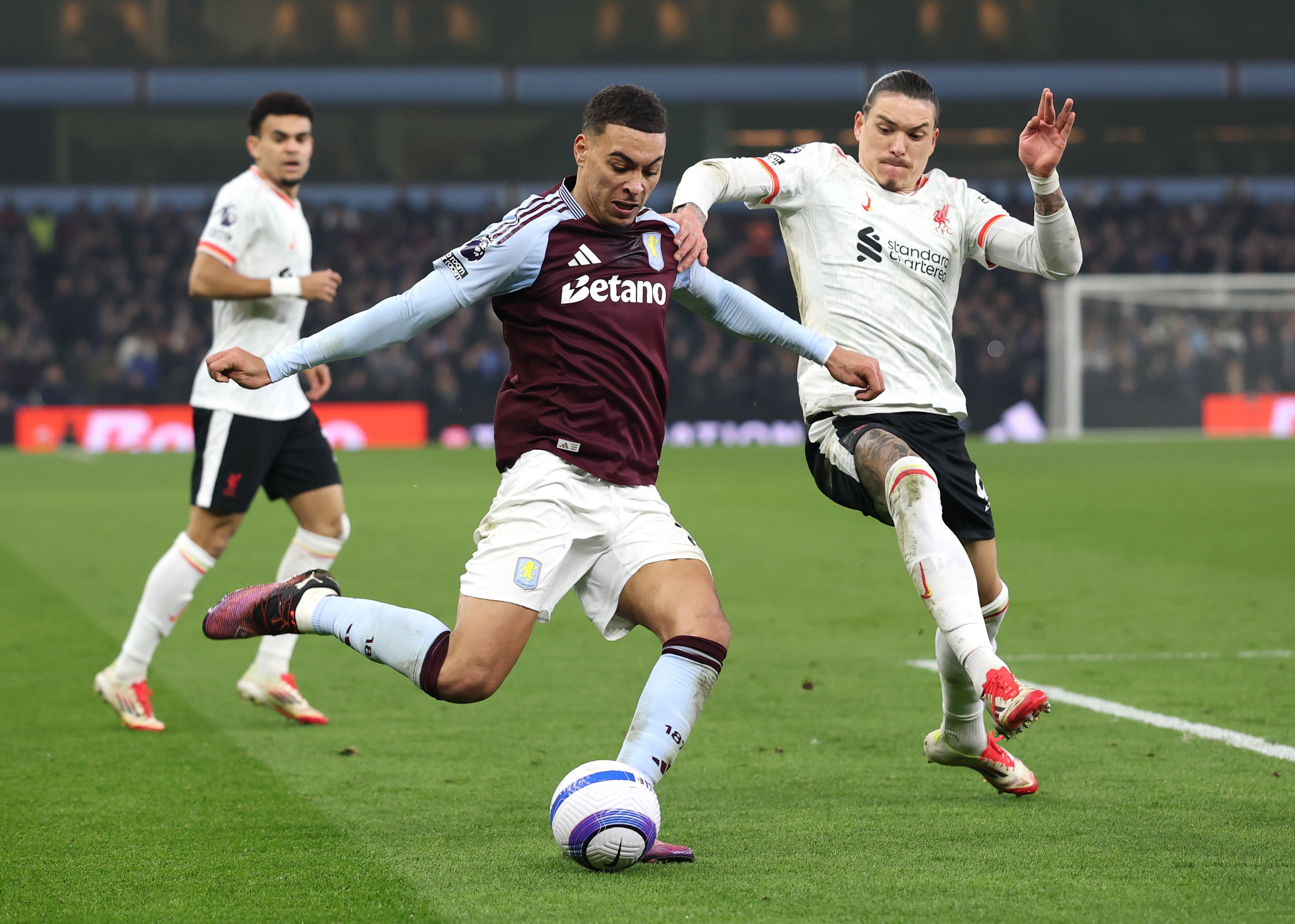 Darwin Nunez challenges Morgan Rogers for possession at Villa Park.