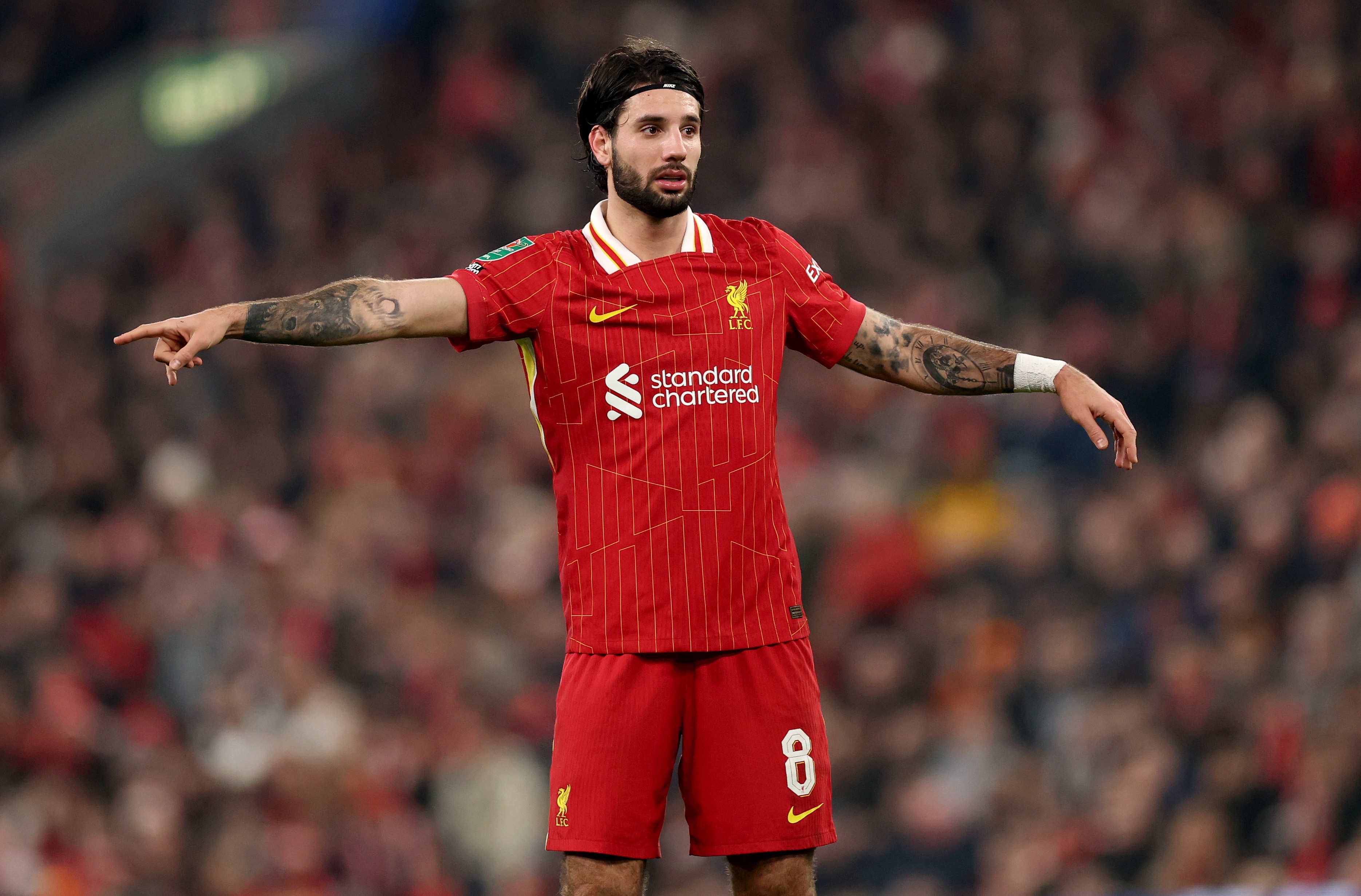 Dominik Szoboszlai points over to his right during a Liverpool match.