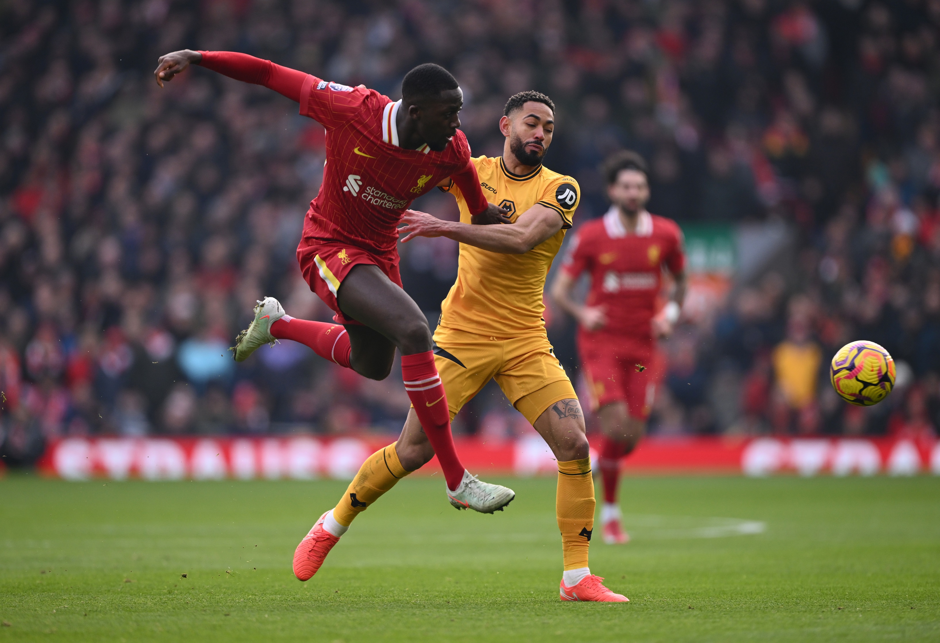 Liverpool defender Ibrahima Konate tackles Wolves attacker Matheus Cunha.