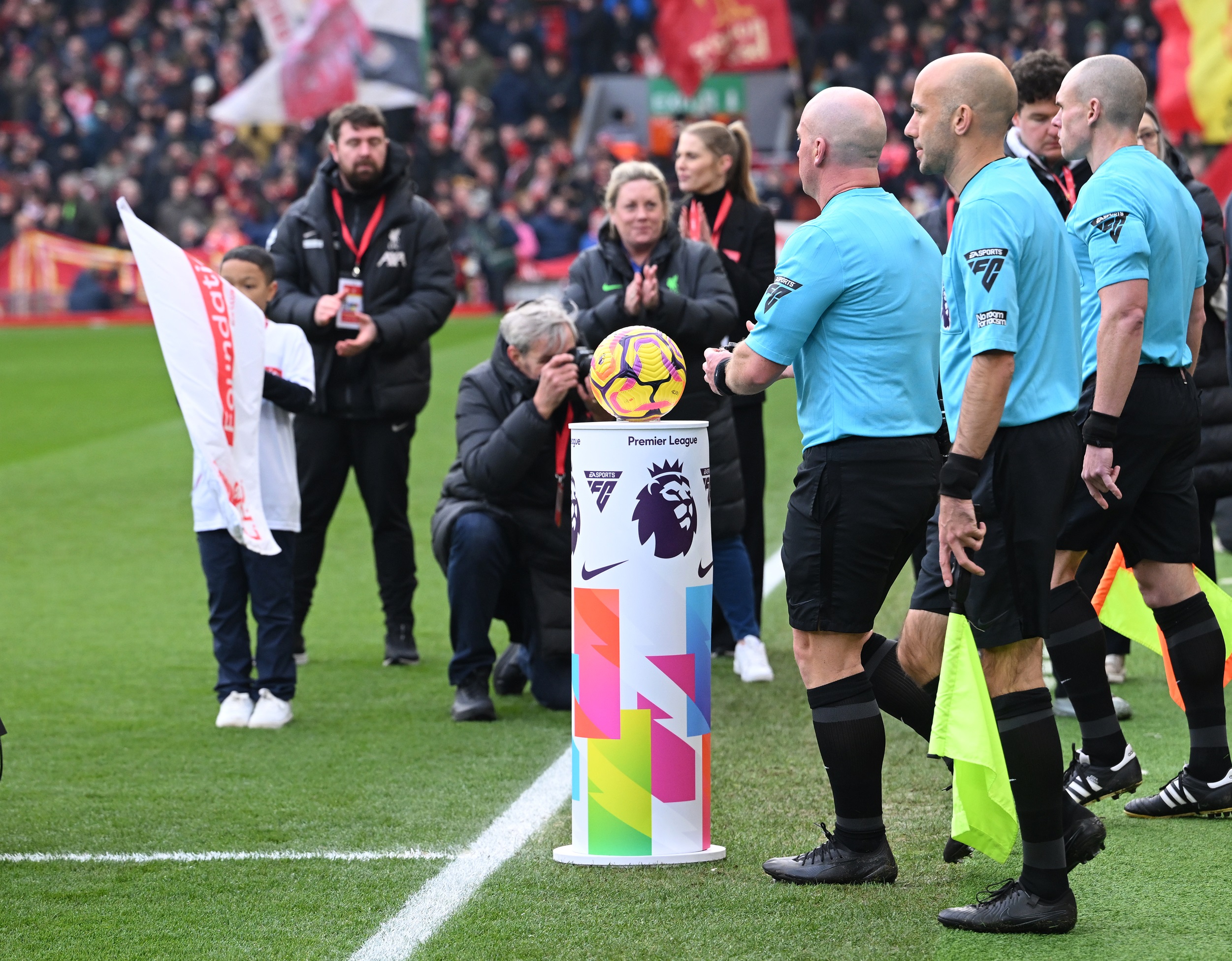 Match officials prepare to take the football ahead of Liverpool game.