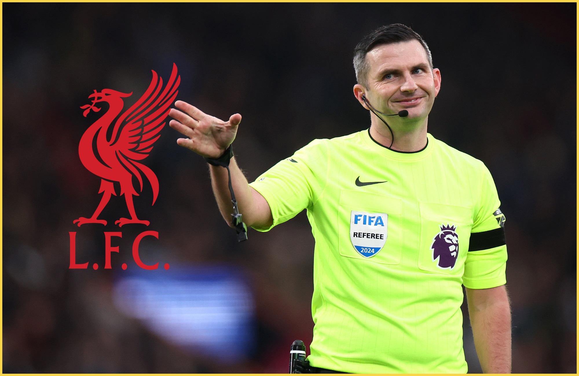 Michael Oliver smiles at Liverpool club crest.
