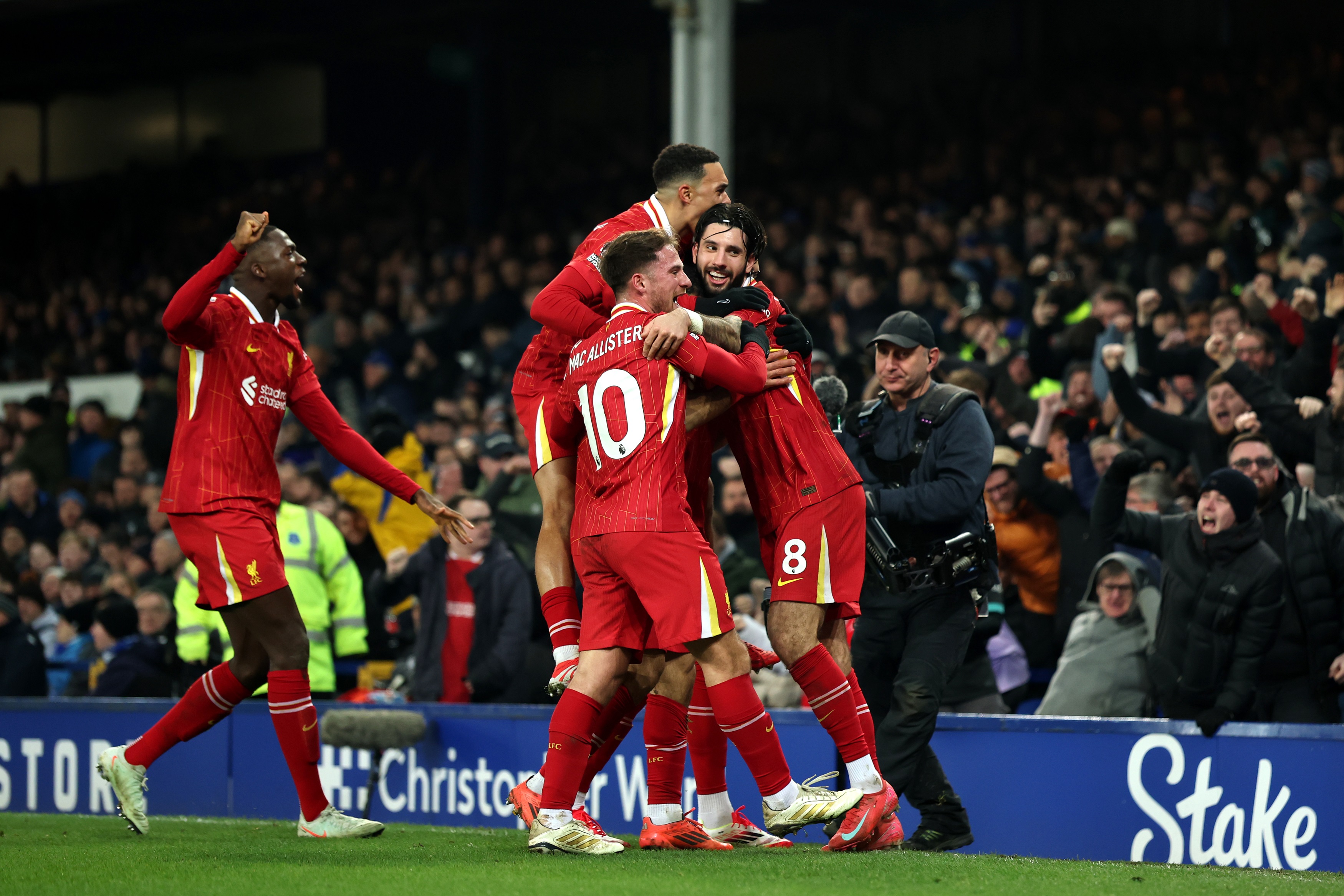 Liverpool players mob Mo Salah in celebration after his Everton goal.