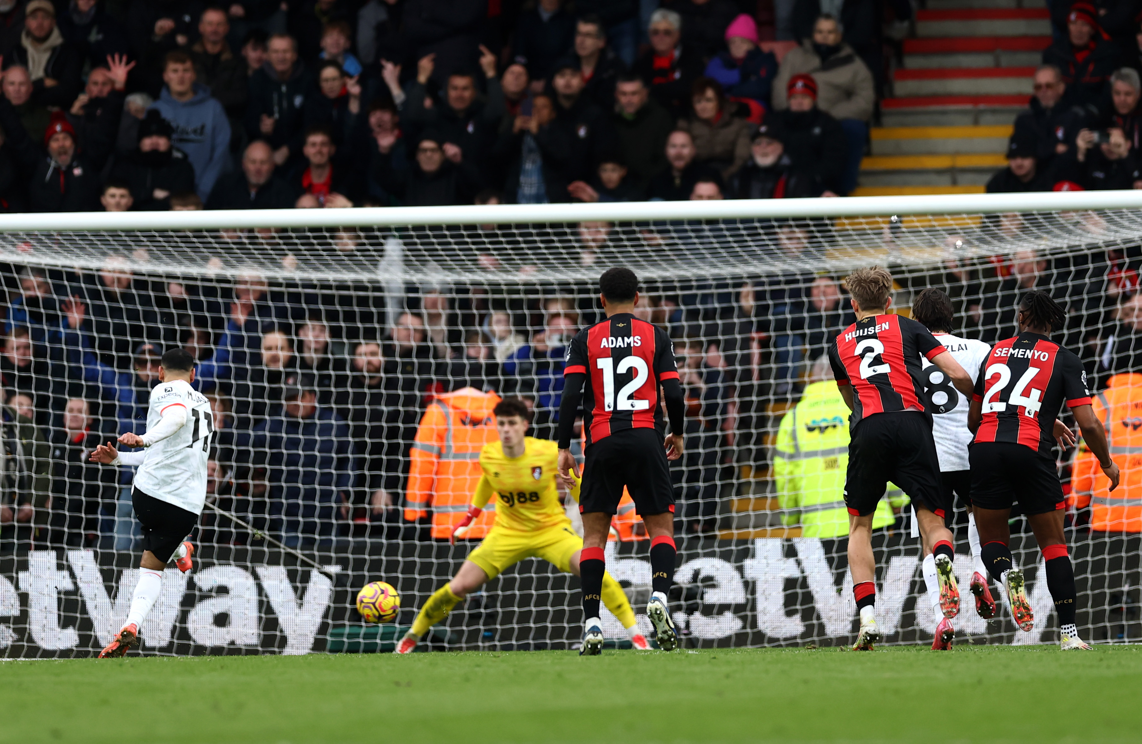 Mo Salah shoots his penalty past Kepa Arrizabalaga.