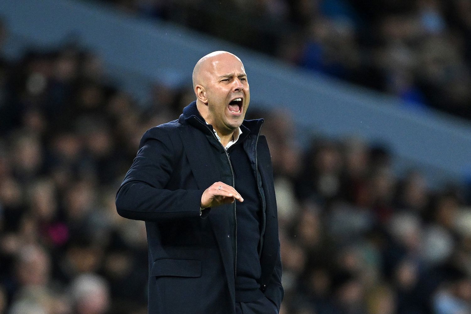 Arne Slot coaches Liverpool against Manchester City