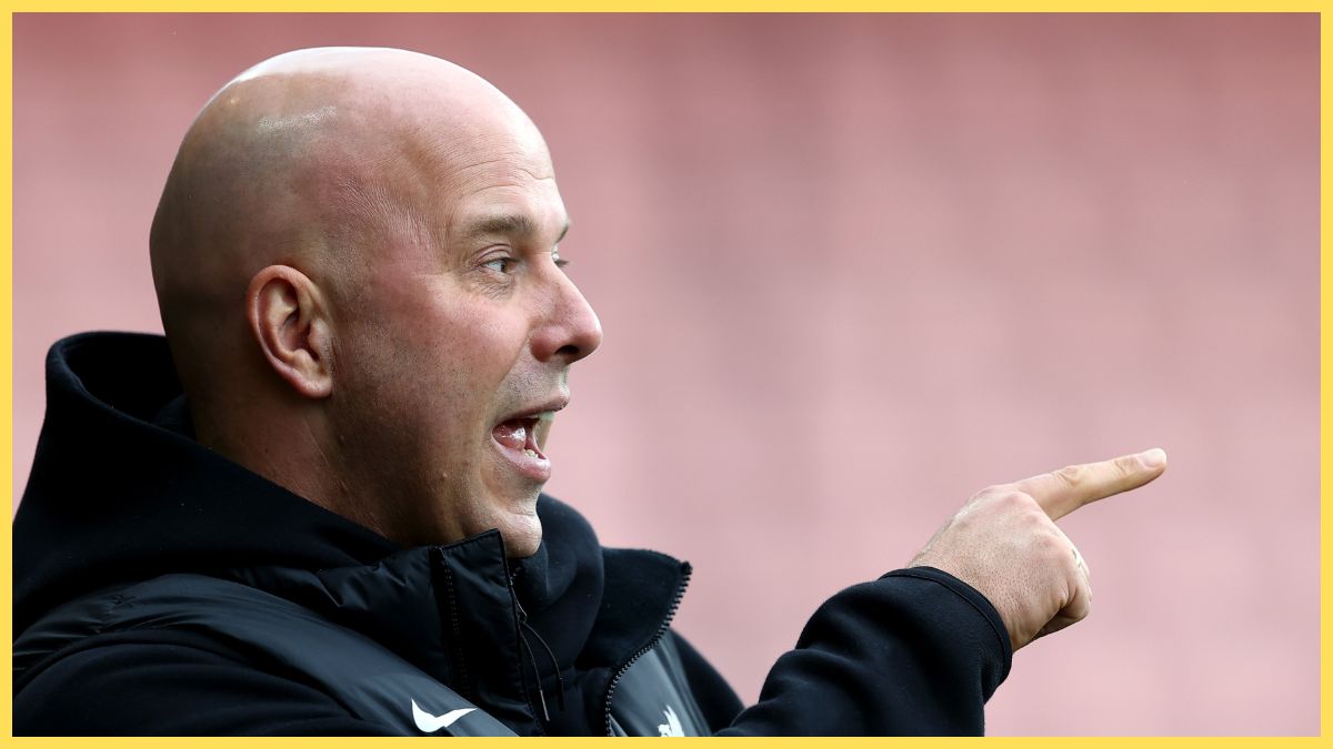 Arne Slot points at something in the distance at the Vitality Stadium.